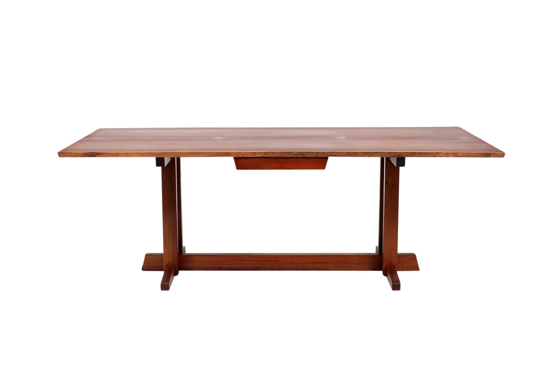 Extremely rare Nakashima Frenchman's cove desk in walnut with four rosewood butterfly's.
Desk was executed for Mr. Wallace a partner at the law firm Coopers & Lybrand and interior by Paul Planert Design of Pittsburgh PA.

Desk with full