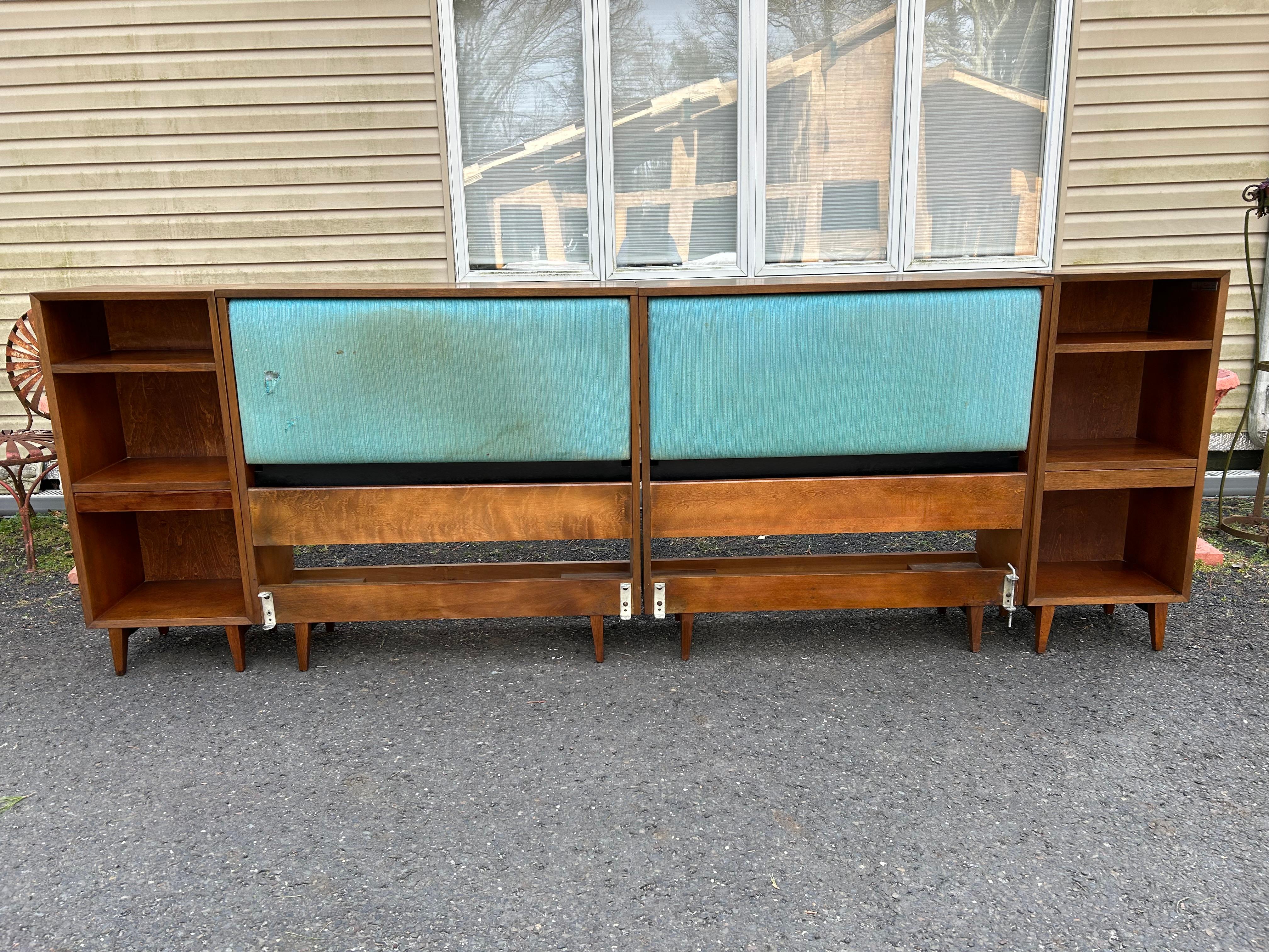 Rare classic George Nelson 4 piece headboard with matching night stands.
An adjustable, padded panel allows for open or closed storage on the twin headboards which make a king-size when used together.  The top opens on each to provide storage of