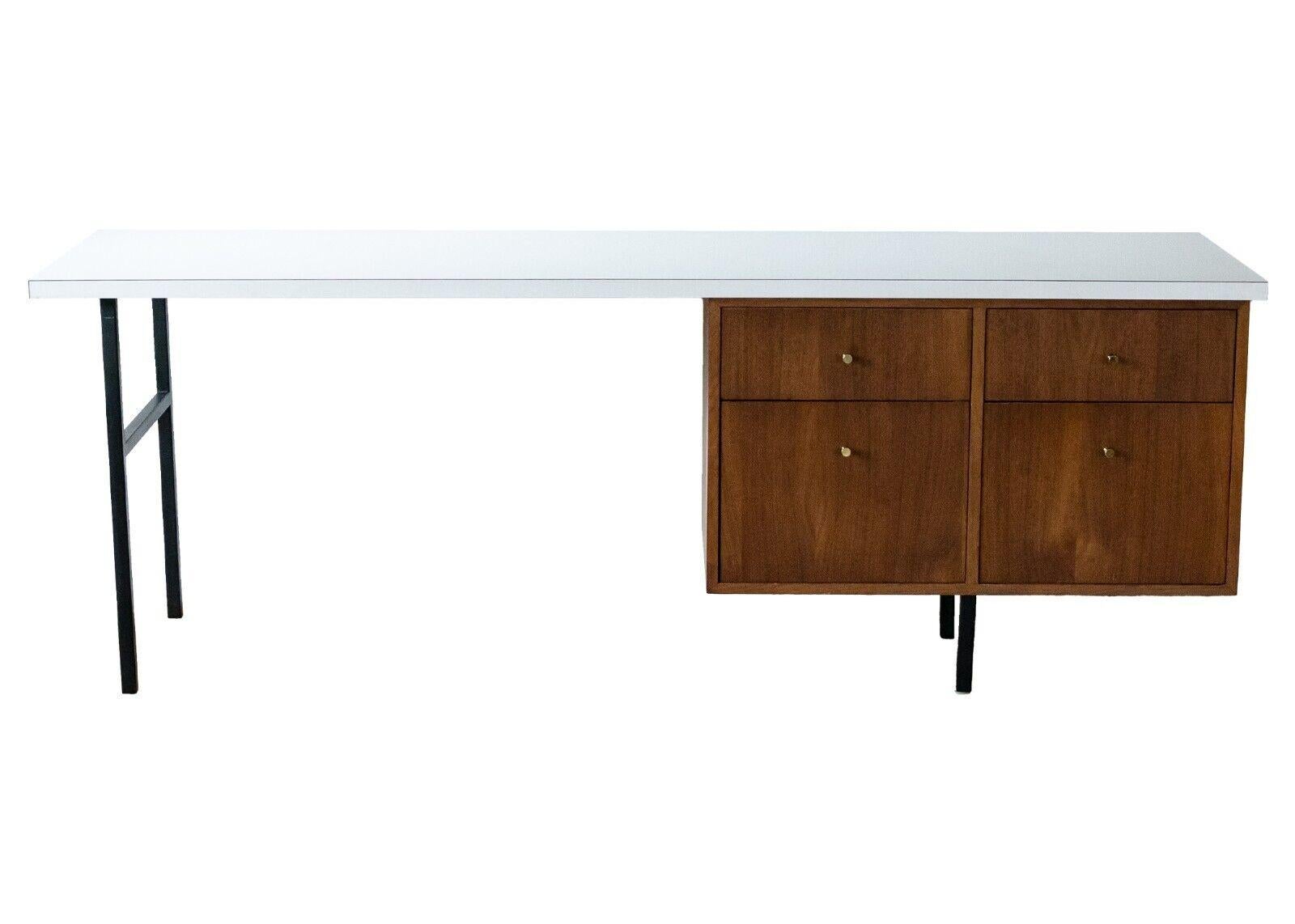 A rare George Nelson executive desk with secretary hutch by Herman Miller. This gorgeous, rare set of pieces are a statement for any office. The George Nelson executive desk features a clean white top and sides with matte black metal legs. The legs