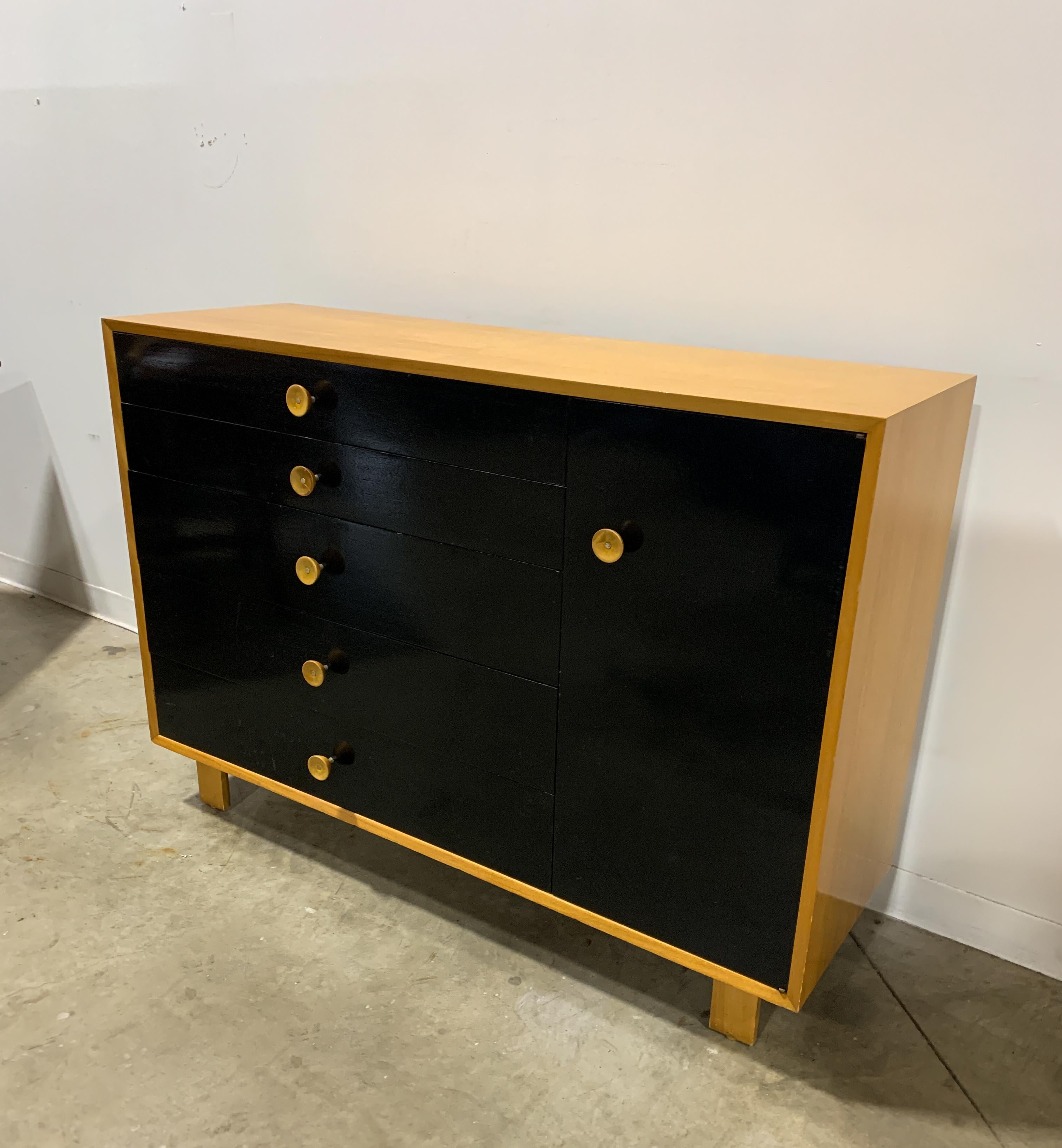 Rare George Nelson designed black front dresser in primavera case from Herman Millers early modern BCS (Basic Cabinet Series) line. Beautiful primavera grain shimmers and the Classic cupcake pulls add further character to the piece. Ample storage