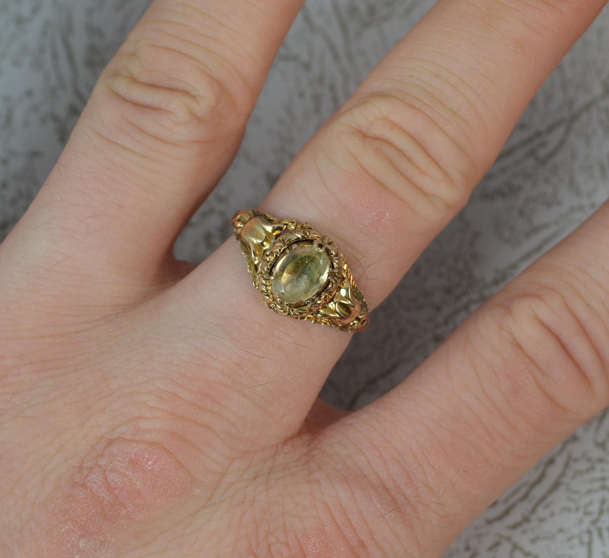 A rare and genuine Georgian III period solitaire ring.
SIZE ; P UK, 7 3/4 US
Solid 15 carat yellow gold example.
5.5mm x 7.5mm oval cut rock crystal in a foiled back closed setting.
Very fine and delicate floral pattern to the surround and