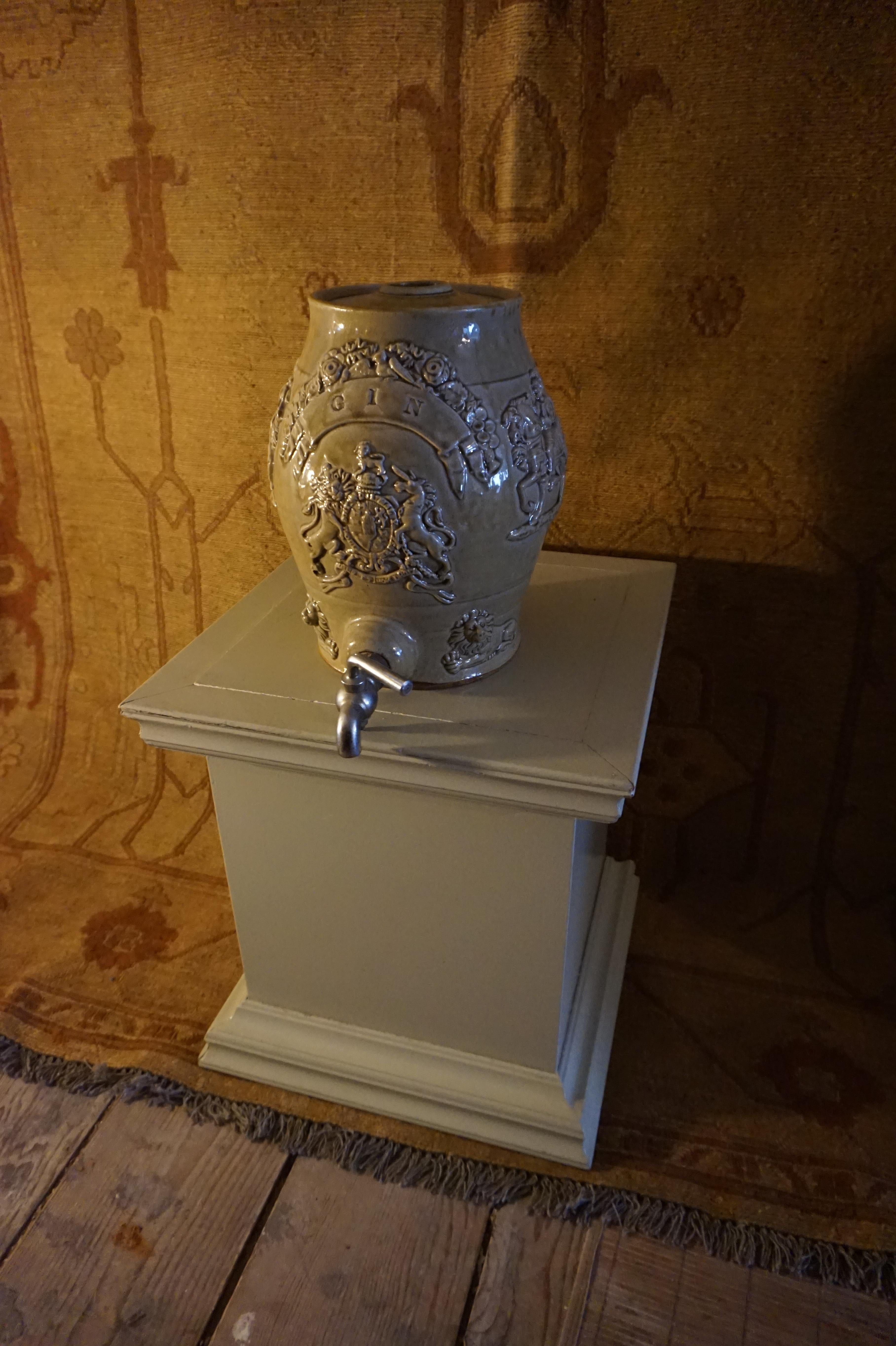 Georgian Gin barrel on tap with Royal coat of arms and depictions of facing knights and seated lions. Latin phrases still visible. Exudes originality as a conversation piece,

circa 1800.