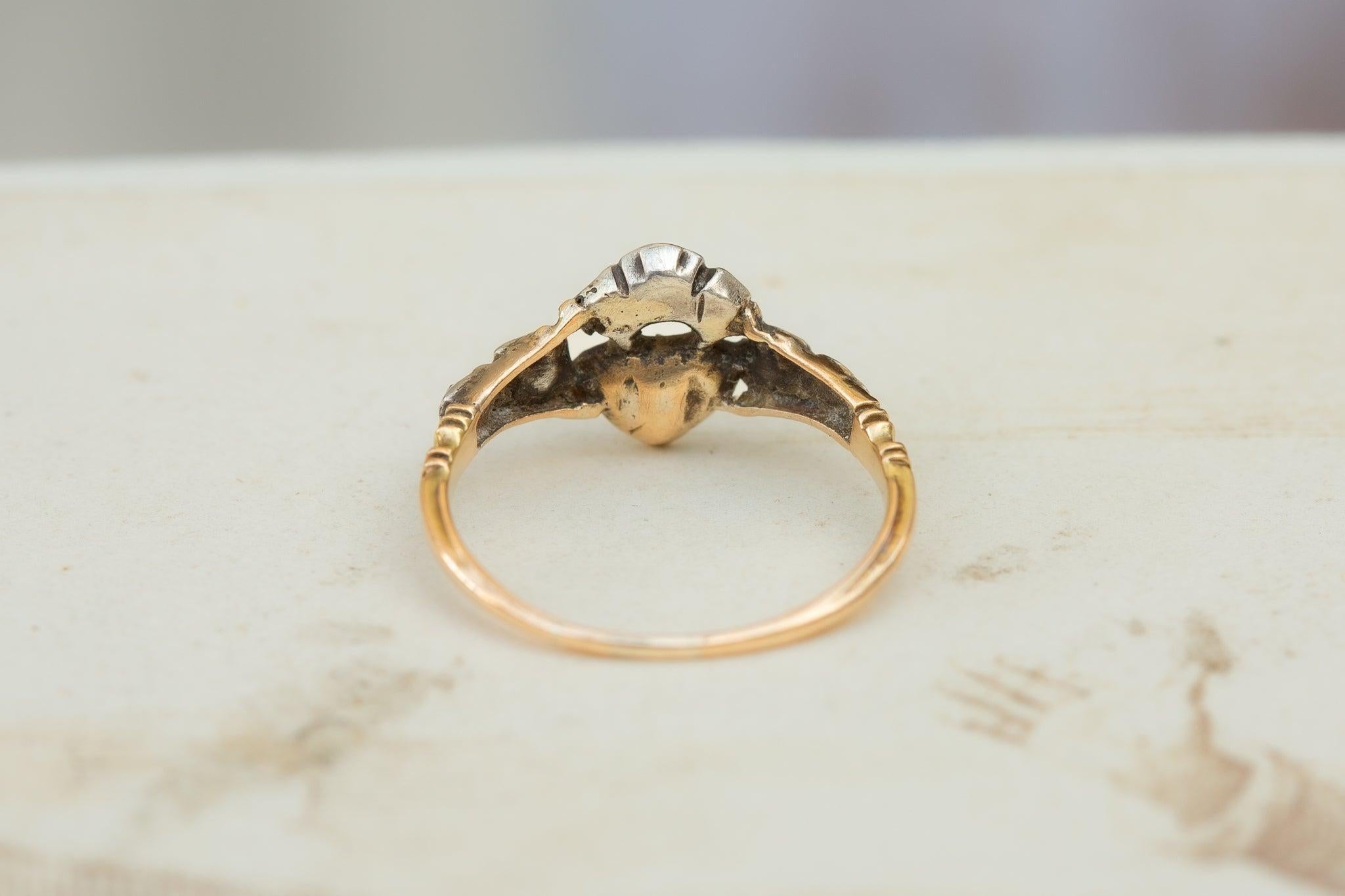 This rare and enchanting early Georgian 'Crowned Heart' ring dates back to circa 1740, a stunning precursor to the modern engagement ring. Such rings were gifted as tokens of love and devotion, symbolising a deep and enduring commitment.

Crafted in