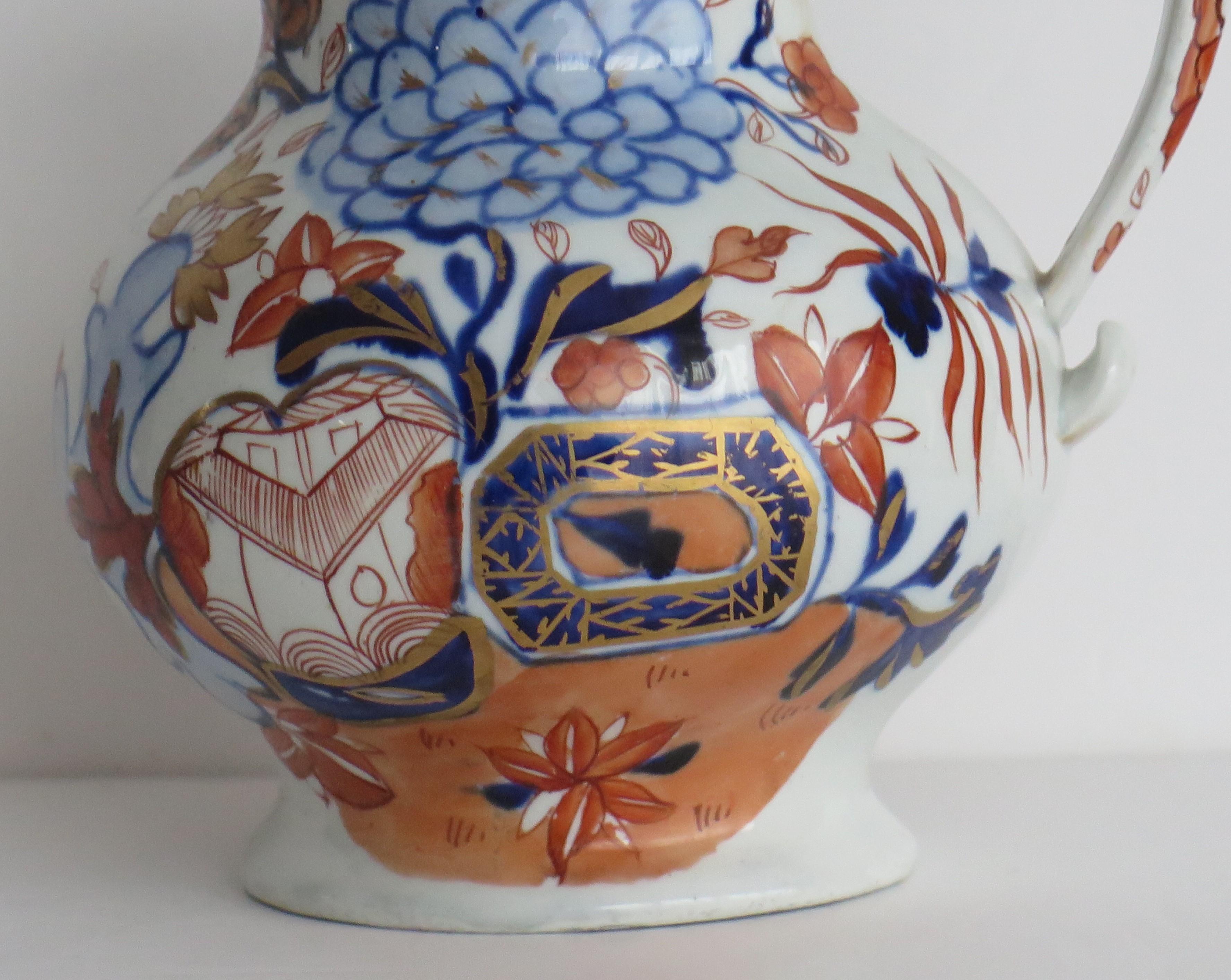 This is a rare early Jug or Pitcher in a rare shape, hand painted in the Jardiniere pattern, made by Mason's Ironstone, Lane Delph, England and dating to circa 1818.

The pattern is hand painted with typical bold free flowing enamels of cobalt