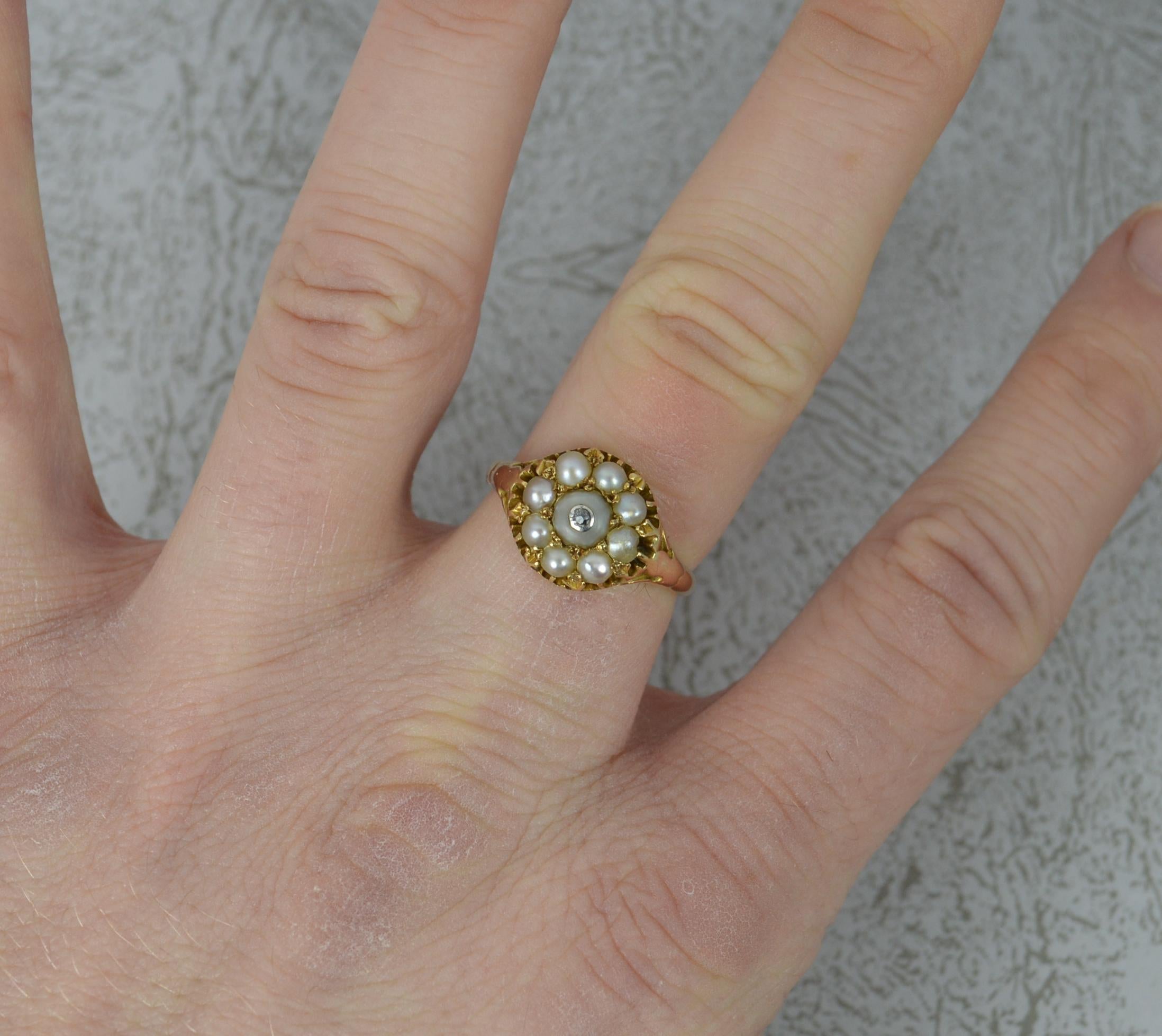 250 / 695 A superb Georgian period cluster ring. 
15 carat gold example. Circa 1820.
Designed with a a cluster of pearls. The centre pearl to have been expertly drilled and set with a tiny rose cut diamond in bezel setting. Something we have never