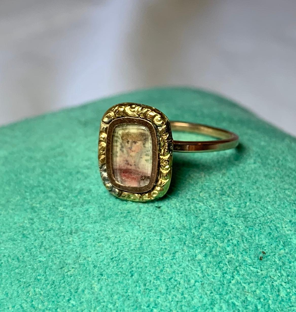 A very early and rare Georgian Portrait Miniature Ring.  The Portrait Miniature is set within the central crystal covered compartment of the ring.  This is very early - most likely dating to the 18th Century.  The portrait is surrounded by a gold