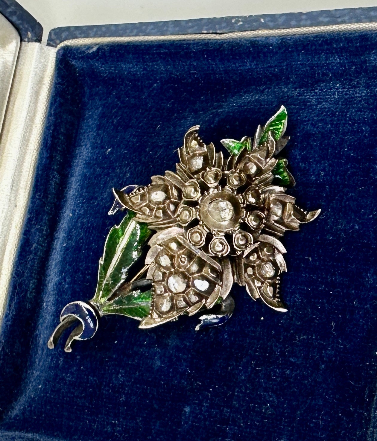 Indulge in a rare early Rose Cut Diamond Enamel Flower Pendant or Brooch dating to the Georgian to Victorian Era set with an abundance of antique Rose Cut Diamonds set in silver with a 9 Karat gold pin stem.

Diamonds were all the rage in the