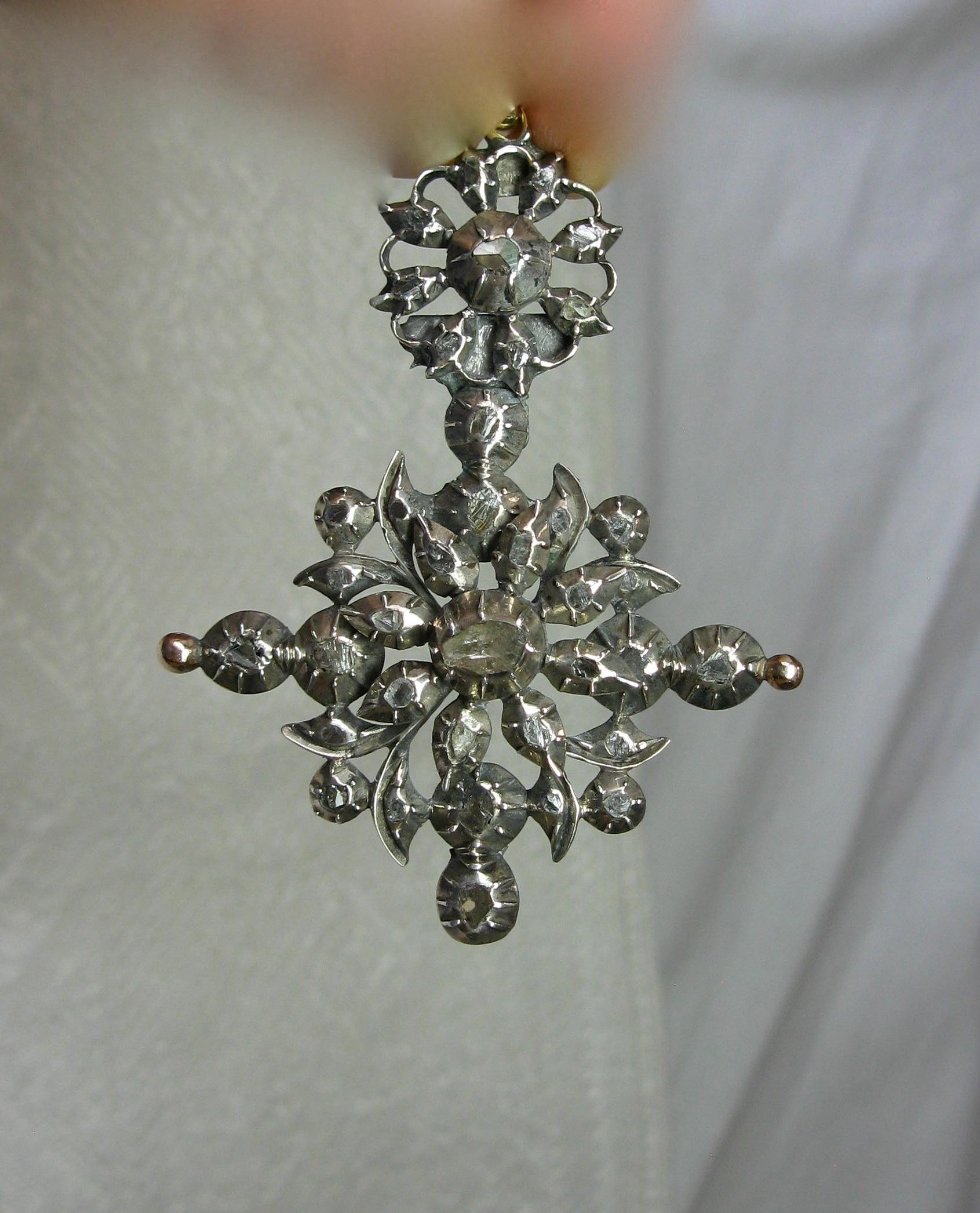 This is a rare museum quality early Rose Cut Diamond Pendant dating to the Georgian Era set with an abundance of antique Rose Cut Diamonds set in silver atop 14 Karat gold as was the custom of the period.  The pendant of great beauty and dating to