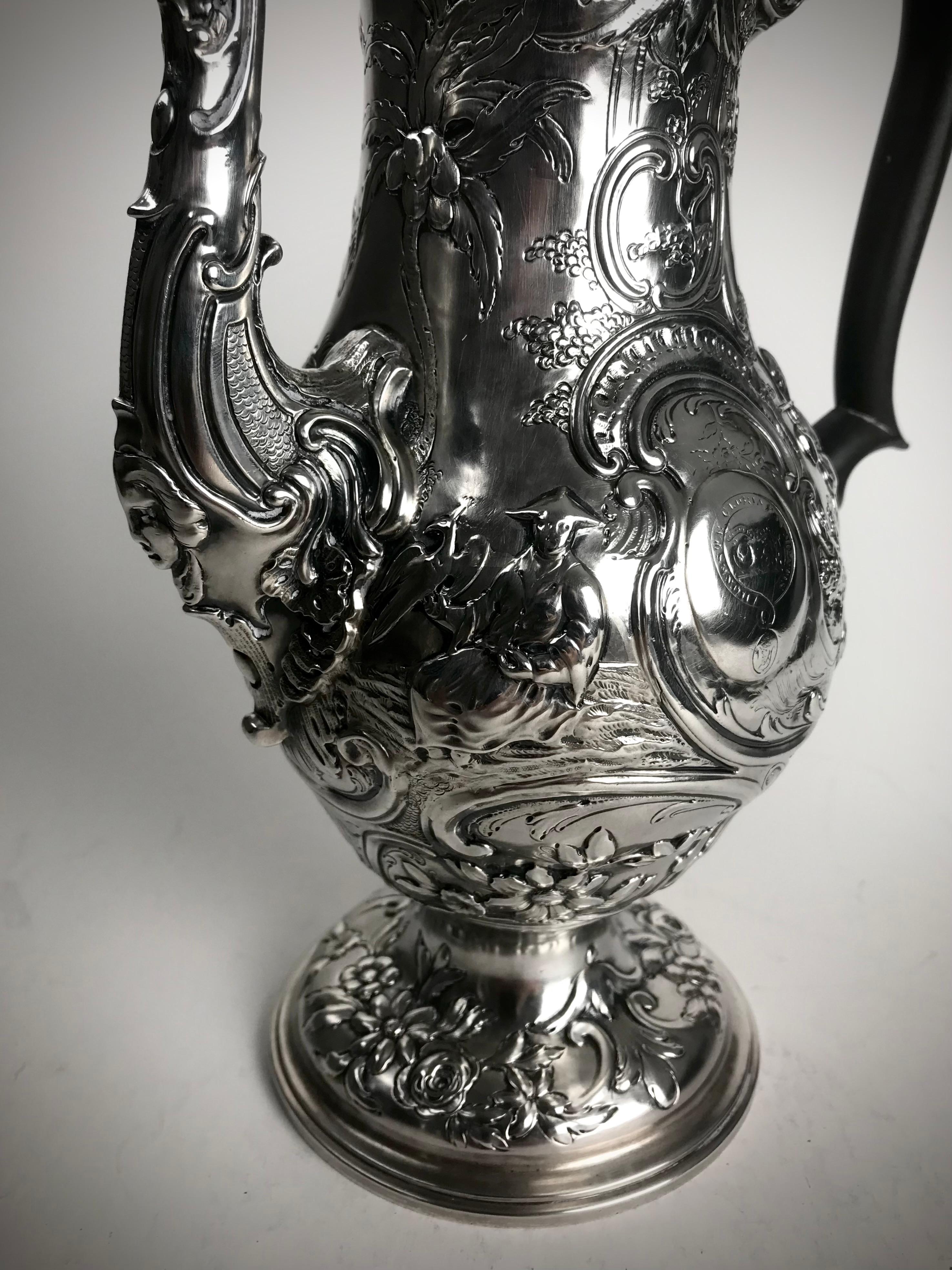 A Magnificent Solid Silver Sterling Slender baluster form Coffee pot with a the raised domed hinged cover embossed and chased with flowers and foliage and 'C' scrolls, crowned with a swirling and Chinese figure finial
A wooden double-scrolled