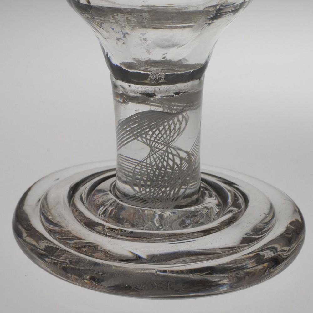 Heading : 18th century rib moulded dram with opaque twist stem and terraced foot
Date : c1760
Period : George II
Origin : England
Colour : Clear
Bowl : Rib moulded ogee bowl with gilded rim
Stem : Double series opaque twist consiting of an 7-ply