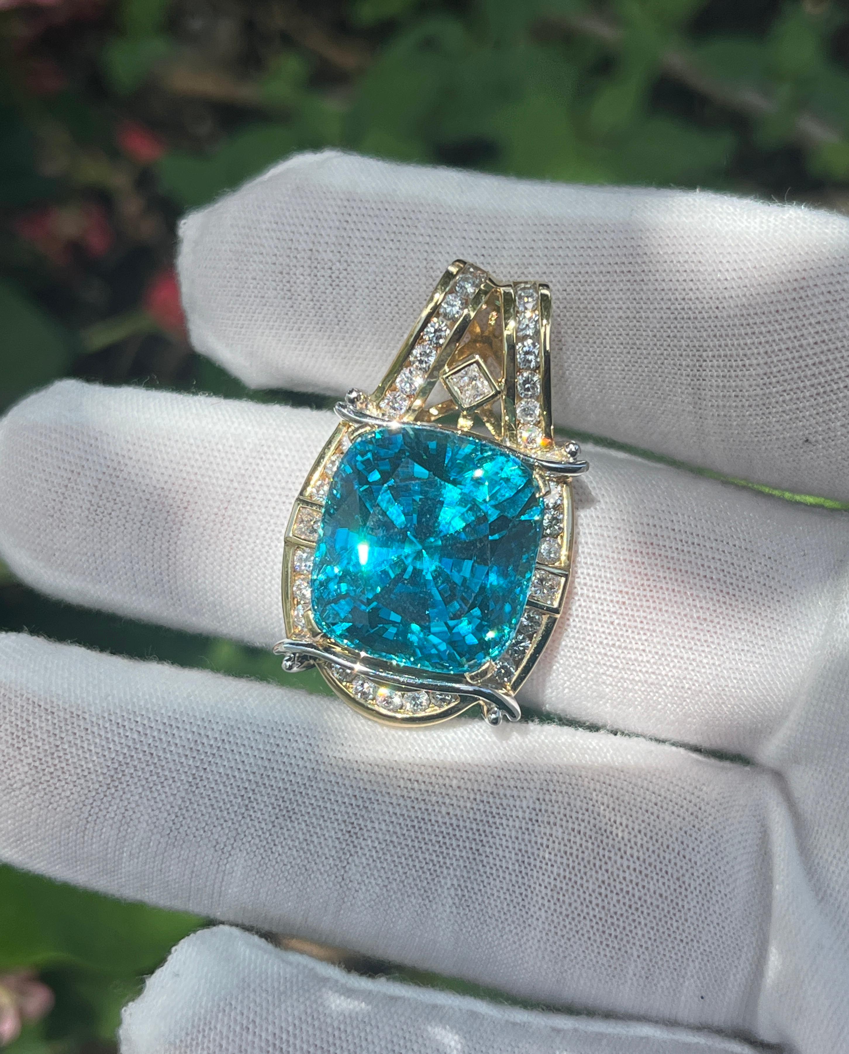 GIA certified brilliant cushion cut greenish blue zircon and diamond pendant necklace. The pendant, expertly crafted with platinum 900 and 18K yellow gold, weighs 26.25 grams and measures 1.50