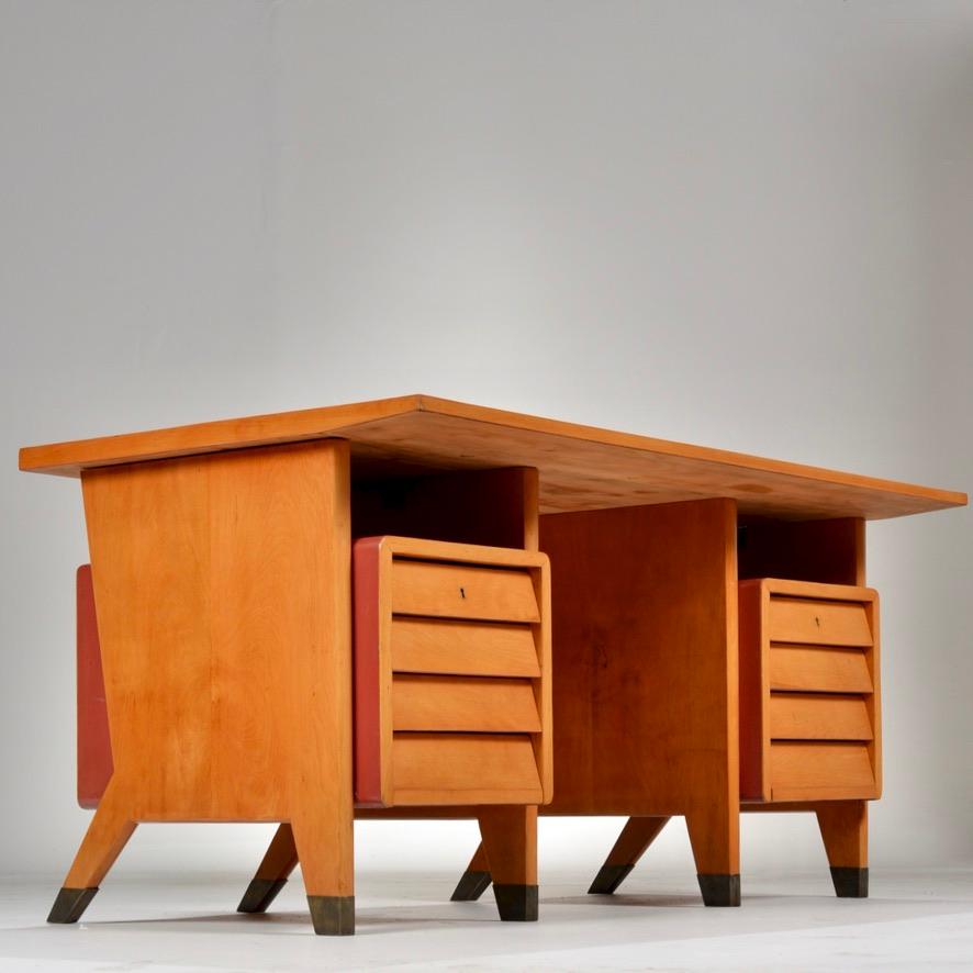 Gio Ponti desk designed in limited edition for city offices of Forlì, Italy. Original red Formica writing surface on European beechwood with 8 floating drawers. Brass base on legs.

All items available to view at our DTLA Arts District Warehouse.