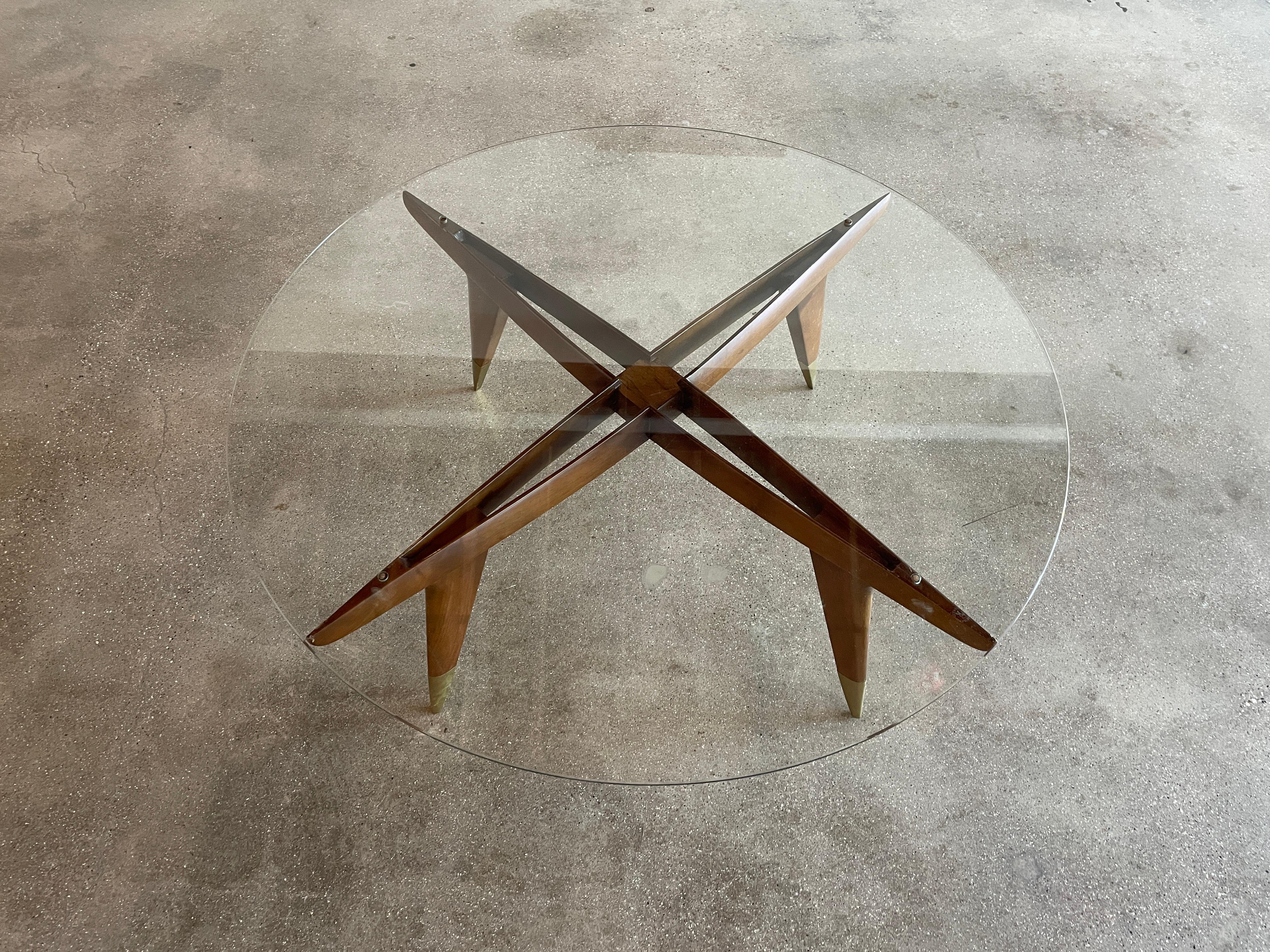 Iconic and rare model 1101 coffee table designed by architect Gio Ponti for M. Singer & Sons, New York, America circa, 1950. The coffee table features distinctive brass feet and is in very good vintage condition. The table retains original tempered