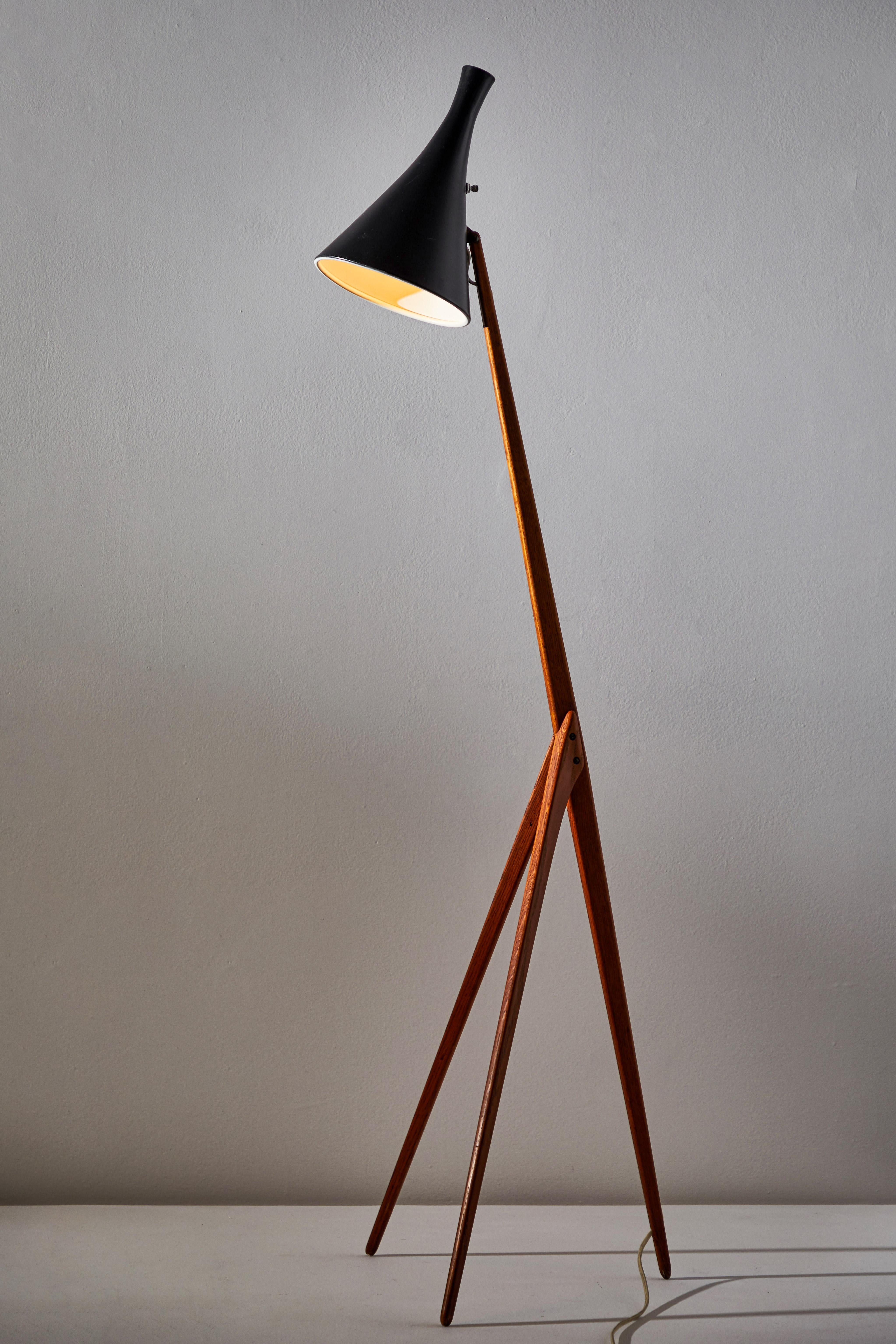 Rare Giraffe floor lamp by Uno & Östen Kristiansson for Luxus. Designed and manufactured in Sweden, circa 1950s. Original cord with U.S. plug. Oak with rare adjustable metal shade. Takes one E26 100w maximum Edison bulb. Bulbs provided as a one time
