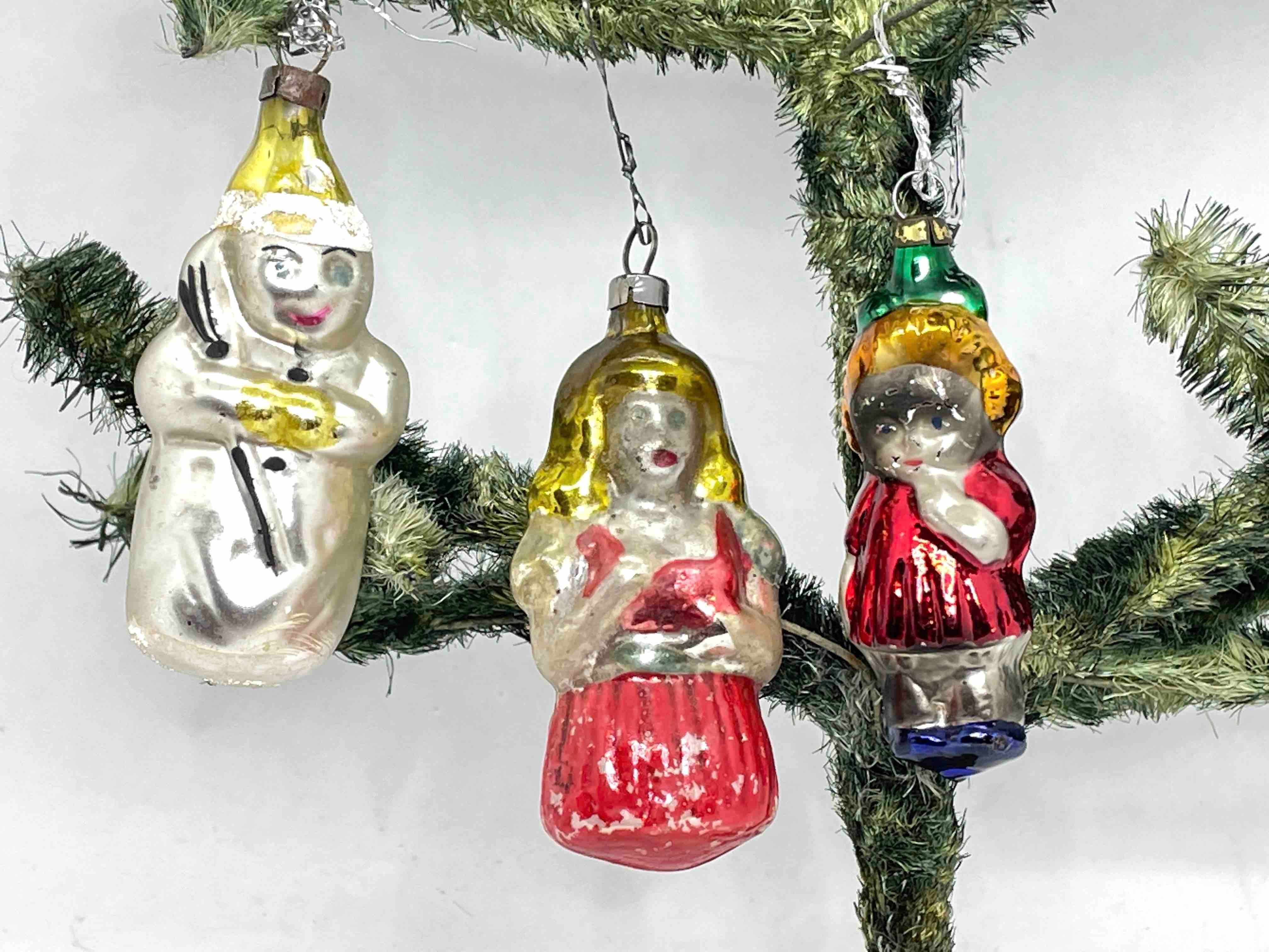 A rare Christmas ornament set of three. Each is made from mouth blown glass, this would be a great addition for your Christmas or feather tree. Snowman is approx. 3 1/4