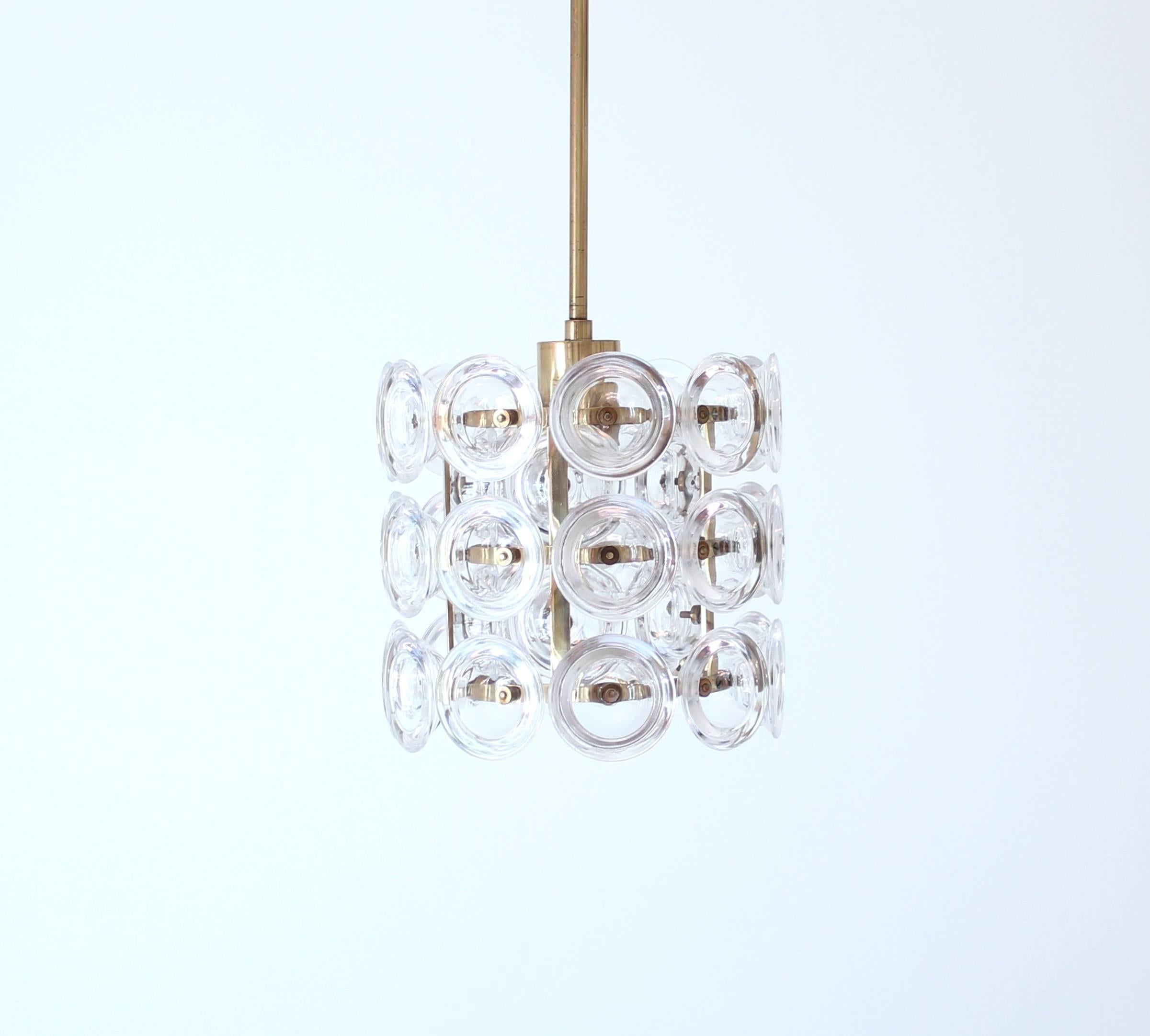 Rare glass and brass pendant designed by Carl Fagerlund for Swedish glass icon Orrefors in the 1960s. It consists of round glass discs on a brass frame. Good vintage condition.