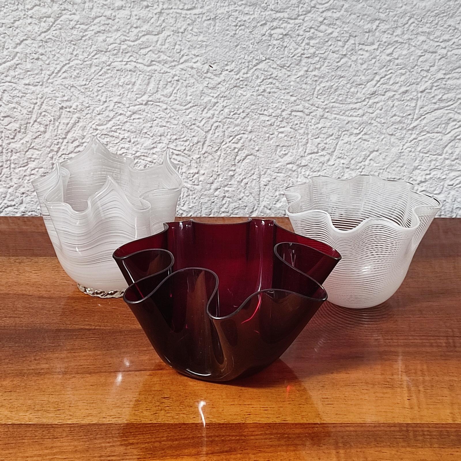 Originally designed by Pietro Chiesa in 1932 for Fontana Arte, this vase is made from one hot folded sheet of glass. This vintage Cartoccio in ruby red glass can be dated from the 1940s. This edition is out of production and no longer available.