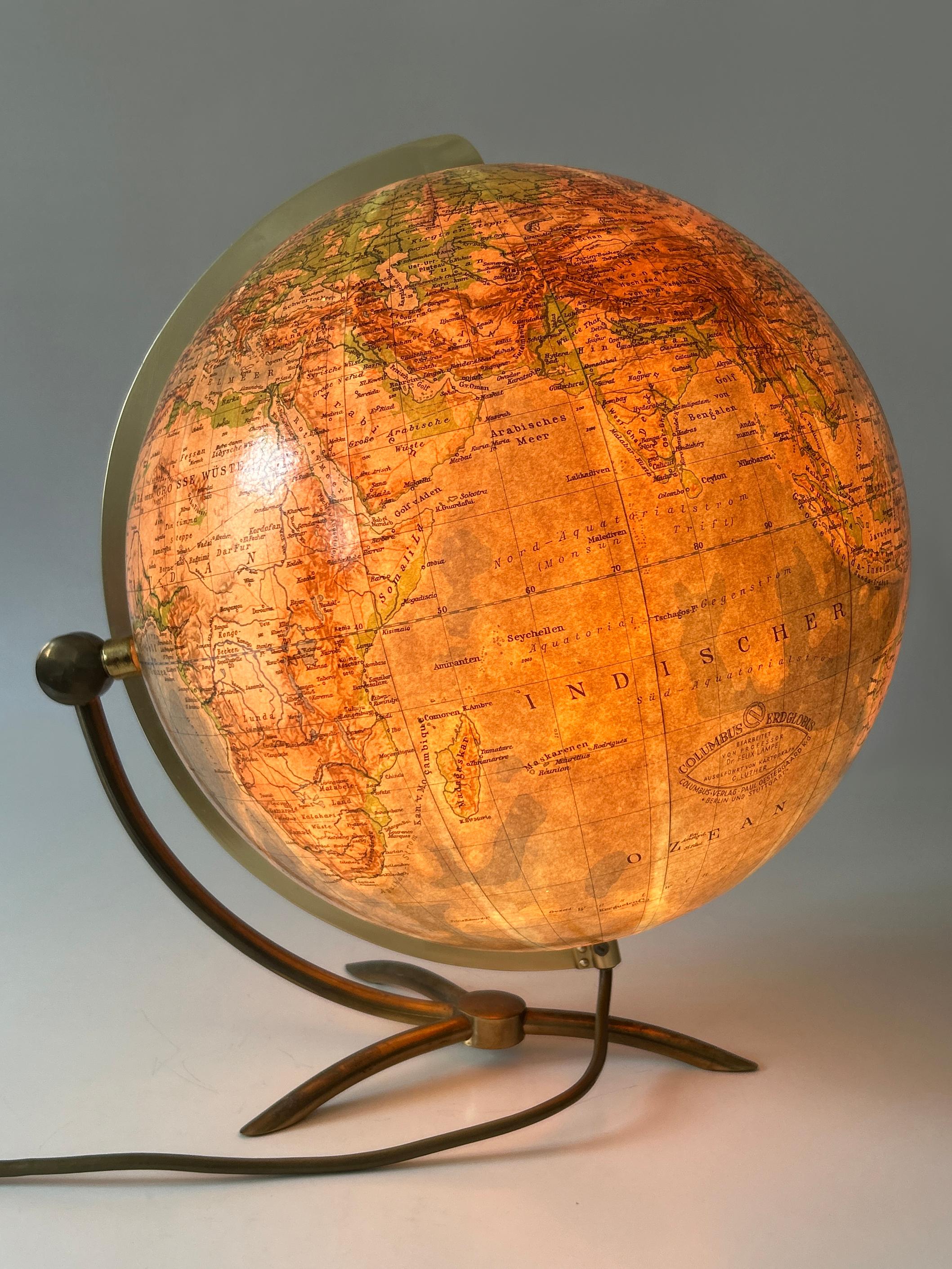 Rare and highly decorative Mid-Century Modern glass earth globe or side table lamp. The globe is illuminated, rotating horizontally and tilting vertically, and can be used as a side table lamp too. Designed and manufactured by Columbus Verlag - Paul