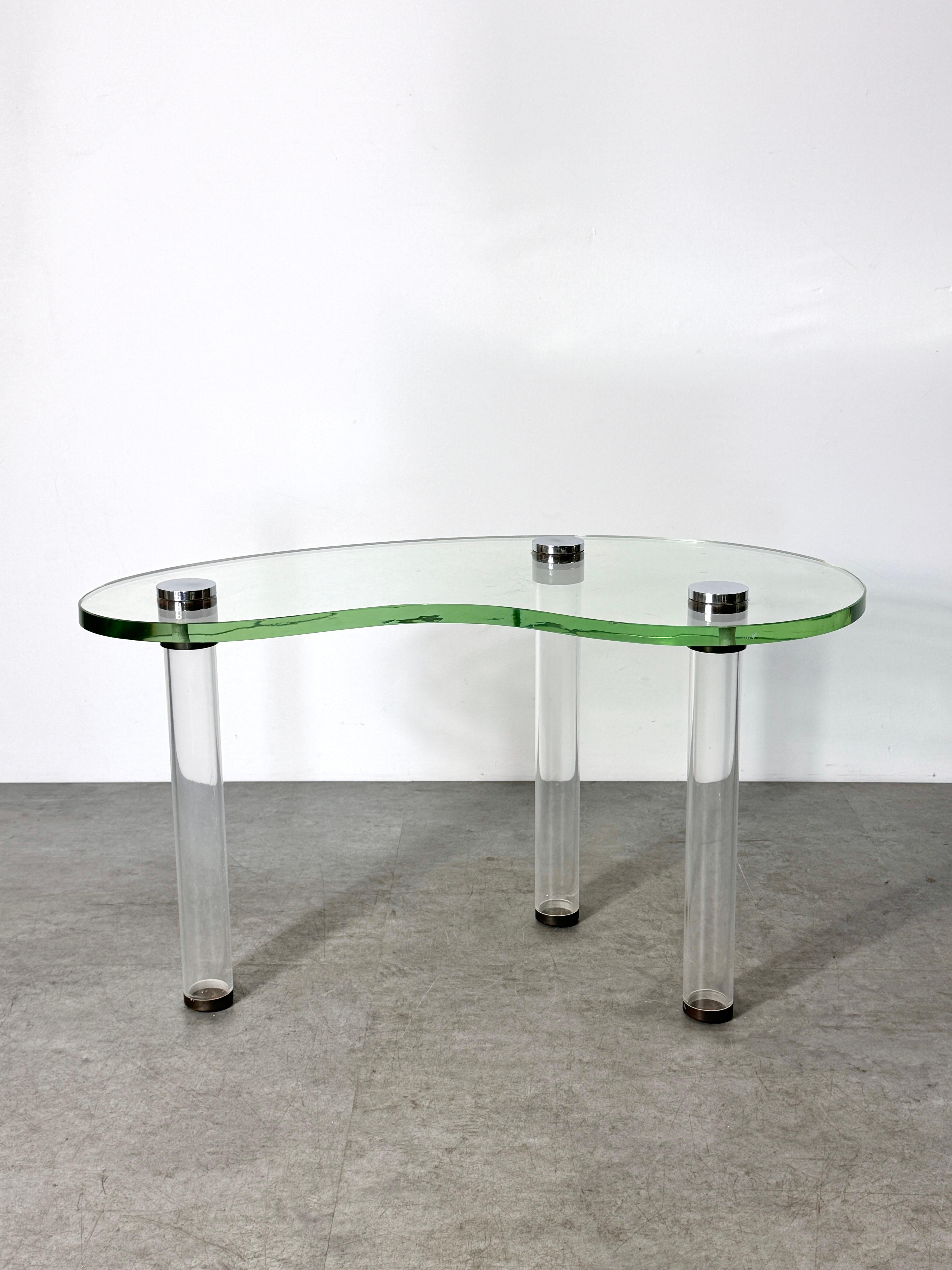 A rare cocktail table from the Herman Miller Luxury Group
Designed by Gilbert Rohde circa 1939-40

Kidney shaped glass surface supported by tubular Lucite legs with chrome plated steel fittings

30 inch width
17.5 inch depth
17 inch height