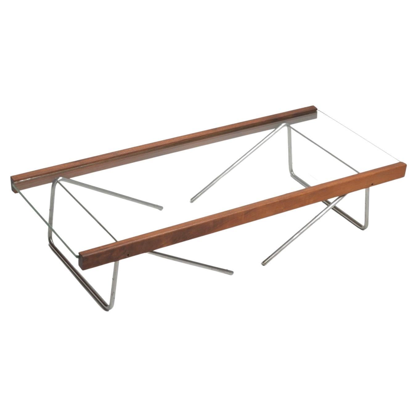 Designed by Honolulu-born Bill Lam. Unique wood accents, stainless steel and glass compliment each other to create this sleek design. Folding legs can be arranged two ways to create a low or medium height coffee table.