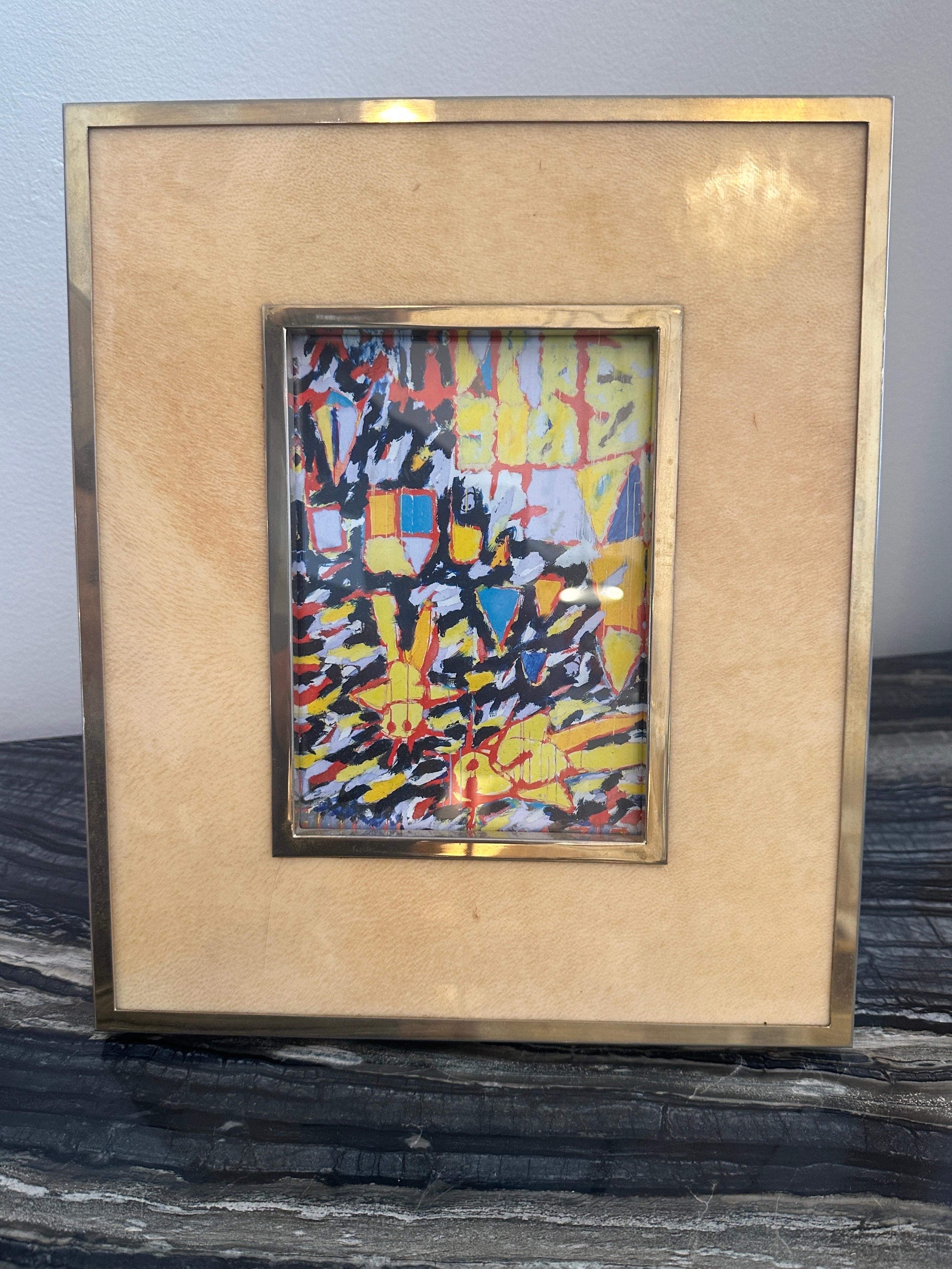 This all original large scale picture frame by Aldo Tura, with stand holds a 5x7 photo.  It is a creamy aged goatskin and golden metal trim.  It retains label to verso.  THIS ITEM IS LOCATED AND WILL SHIP FROM OUR EAST HAMPTON, NY SHOWROOM.