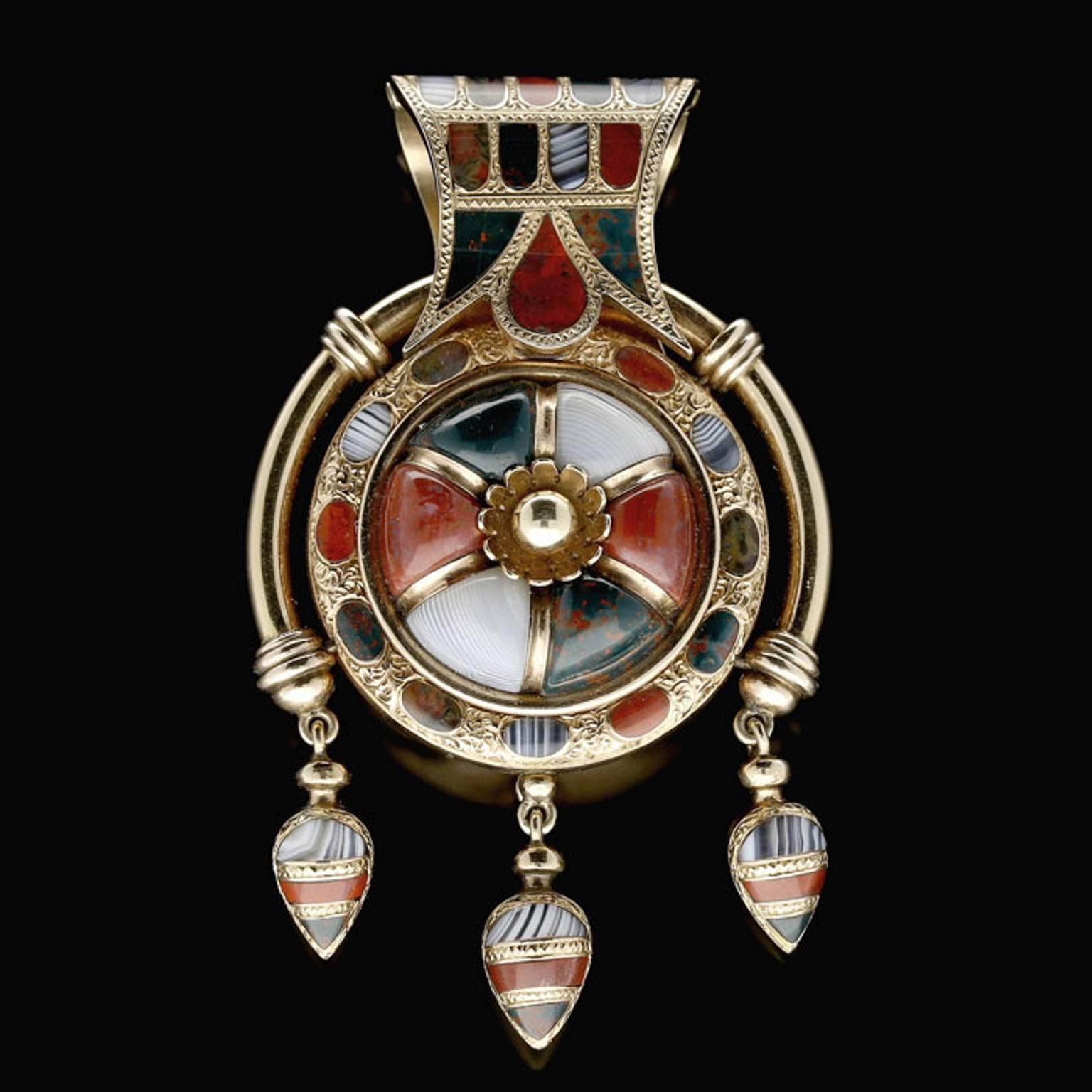 Agate, bloodstone and jasper
18ct yellow gold
6cm long and 3.6cm wide
30 grams

A beautiful gold and Scottish pebble bulla pendant, c. 1870, the striking pendant of Etruscan-inspired 'bulla' design centred on a flower motif with gold bead centre