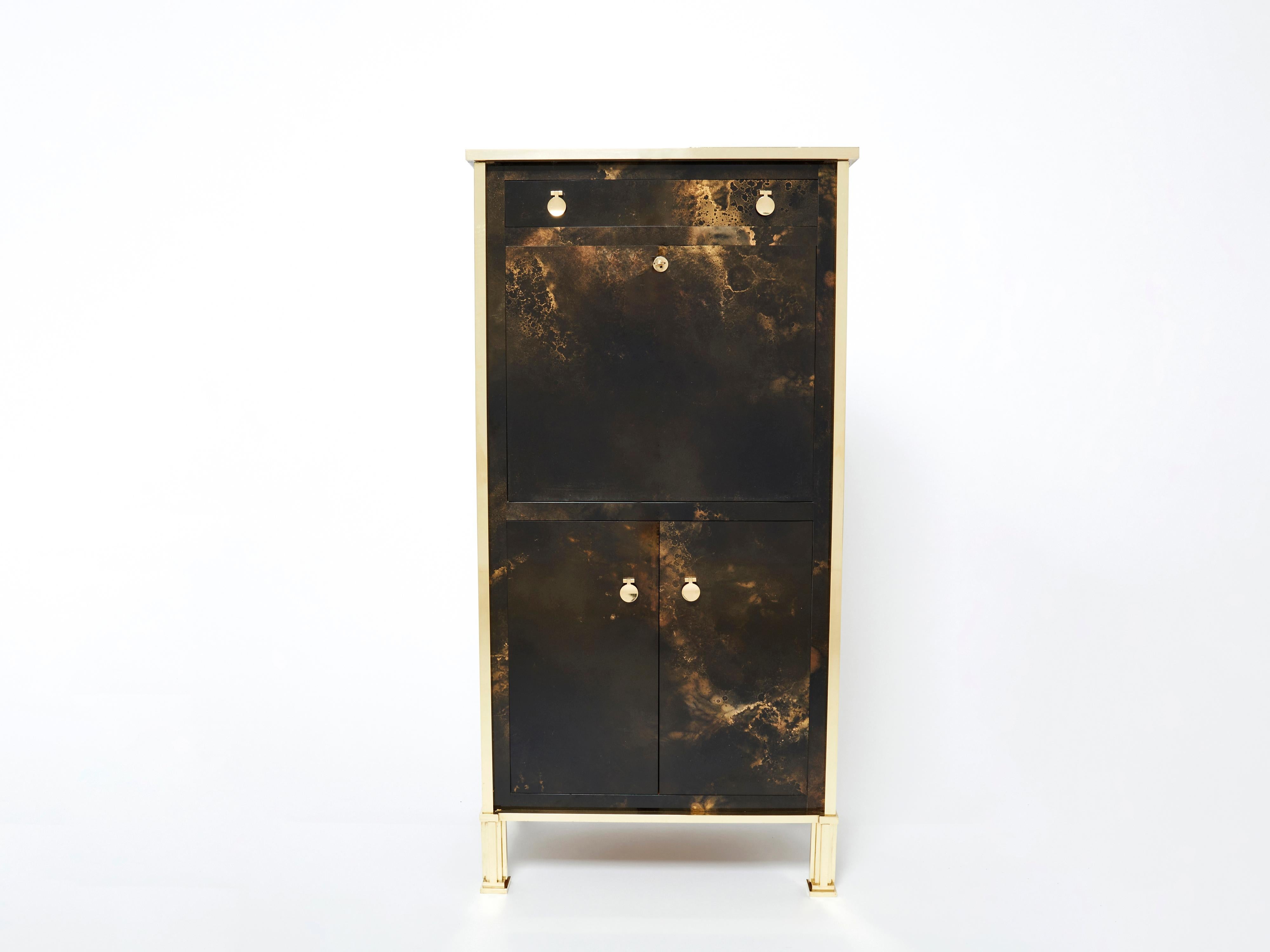 An exciting example of French design firm Maison Jansen’s commissioned pieces. This secretary cabinet is made from solid mahogany, lacquered in a rich dark brown and bronze–golden finish. The resulting effect is a beautiful mottling of color around