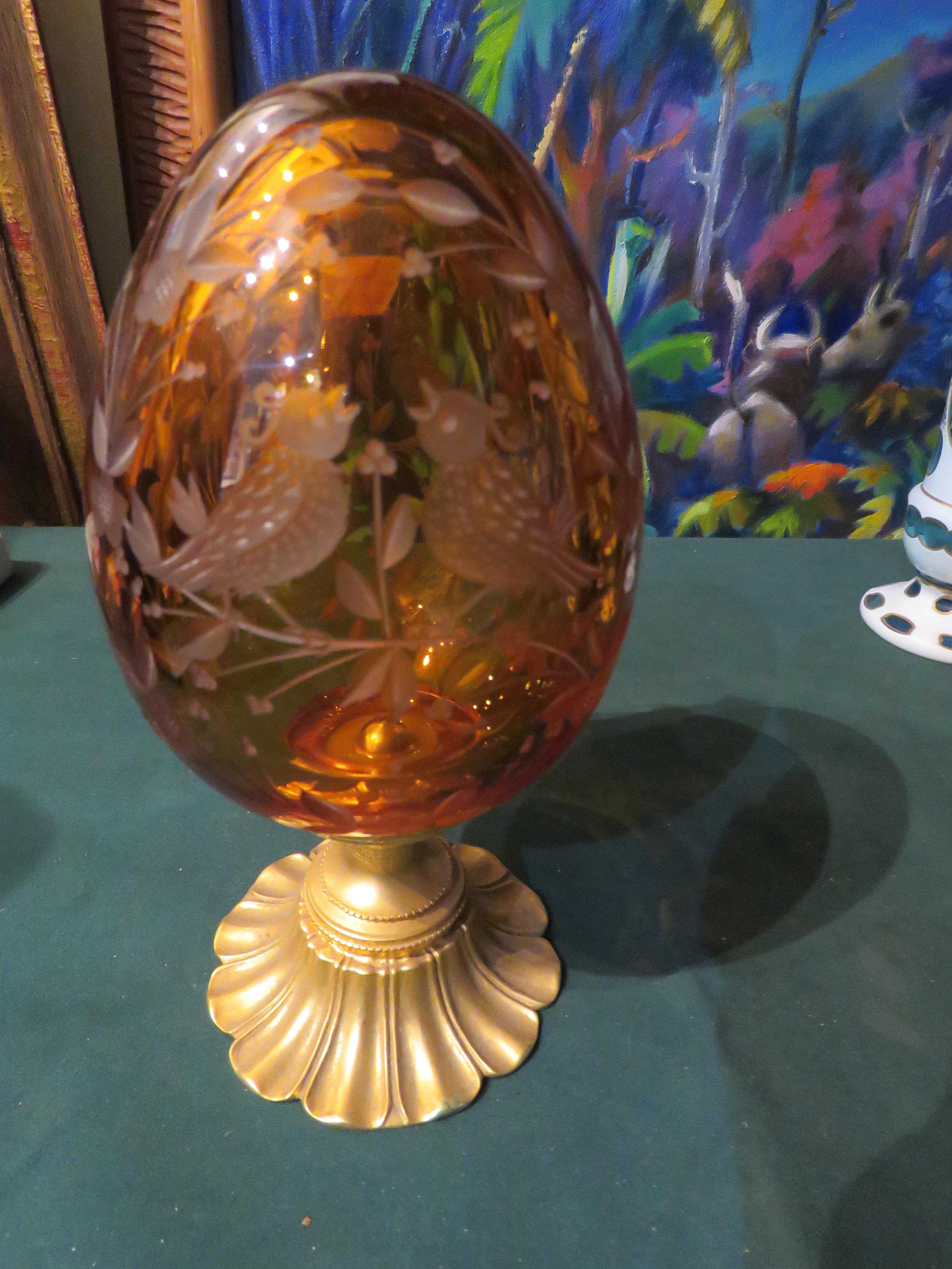 The Following Item we are offering is A Magnificent Beautiful 24KT Gold Leaf Amber Crystal Egg in the style of Faberge. Beautifully done with Fine 24KT Gold Leaf and Gilt Bronze and Intricate Scrolled Detail and Outstanding Handcut Ornate Accent