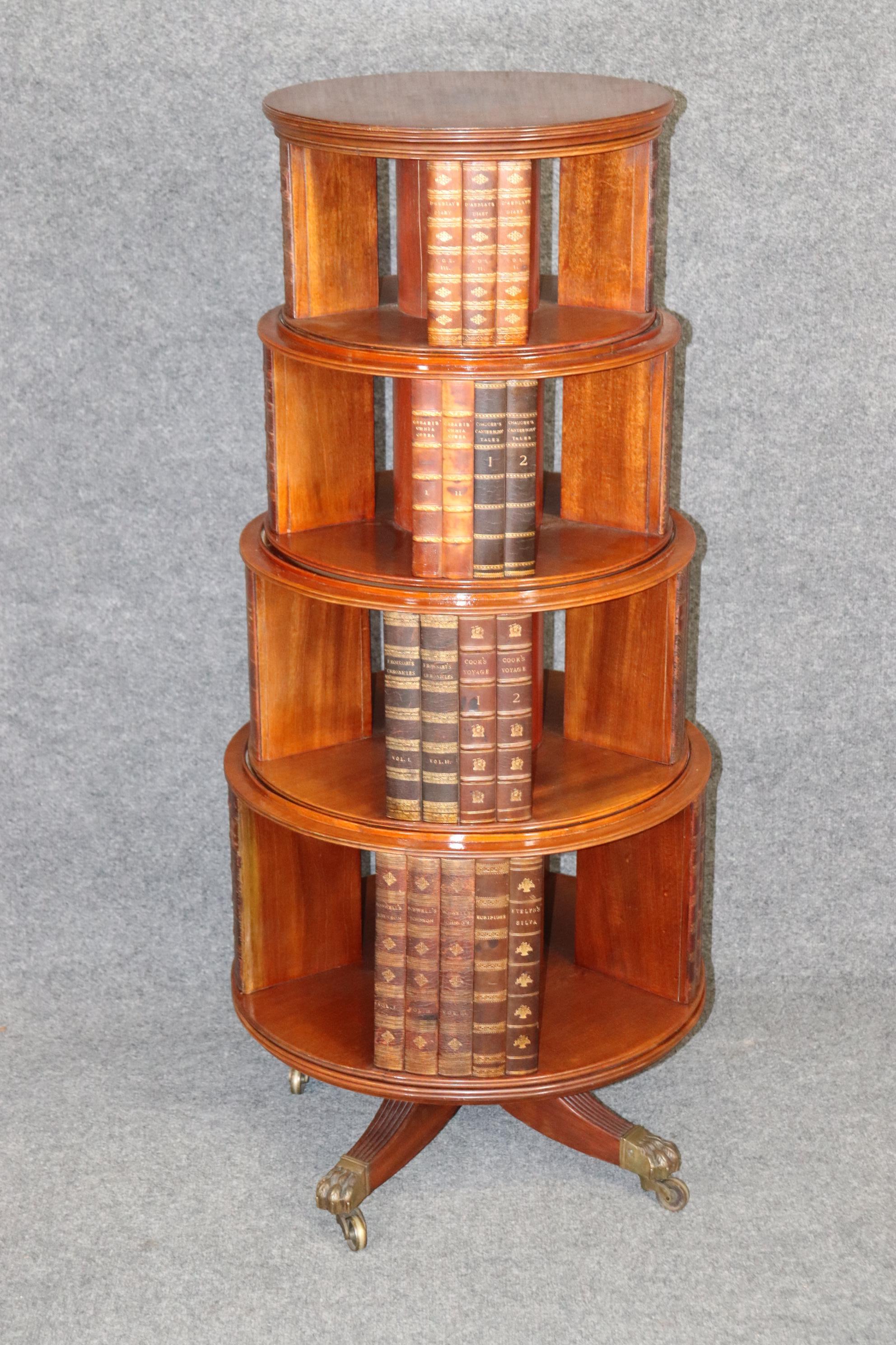 This is a fantastically rare item indeed! This is a George III style solid mahogany revolving bookcase with some of the greatest books ever written from Chaucer and others as dividers (their leather spines not the actual books) and the piece makes a