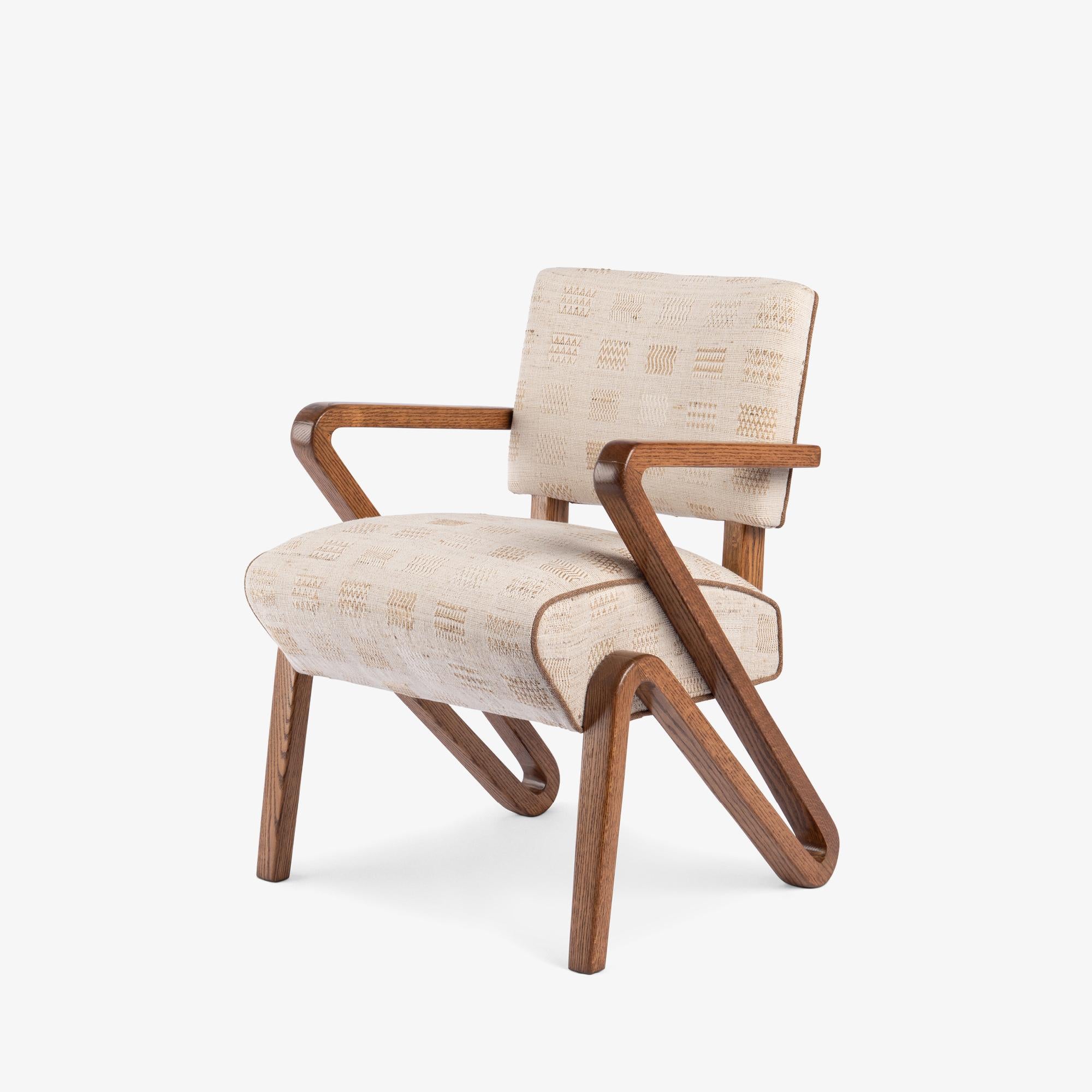 At a Glance:
- Rare Mid-Century sculptural lounge chair with a dramatic grasshopper-inspired profile.
- Solid white oak frame fully restored and finished in a warm medium brown.
- Hand-woven Neeru Kumar Window Weave textile chosen for its subtle