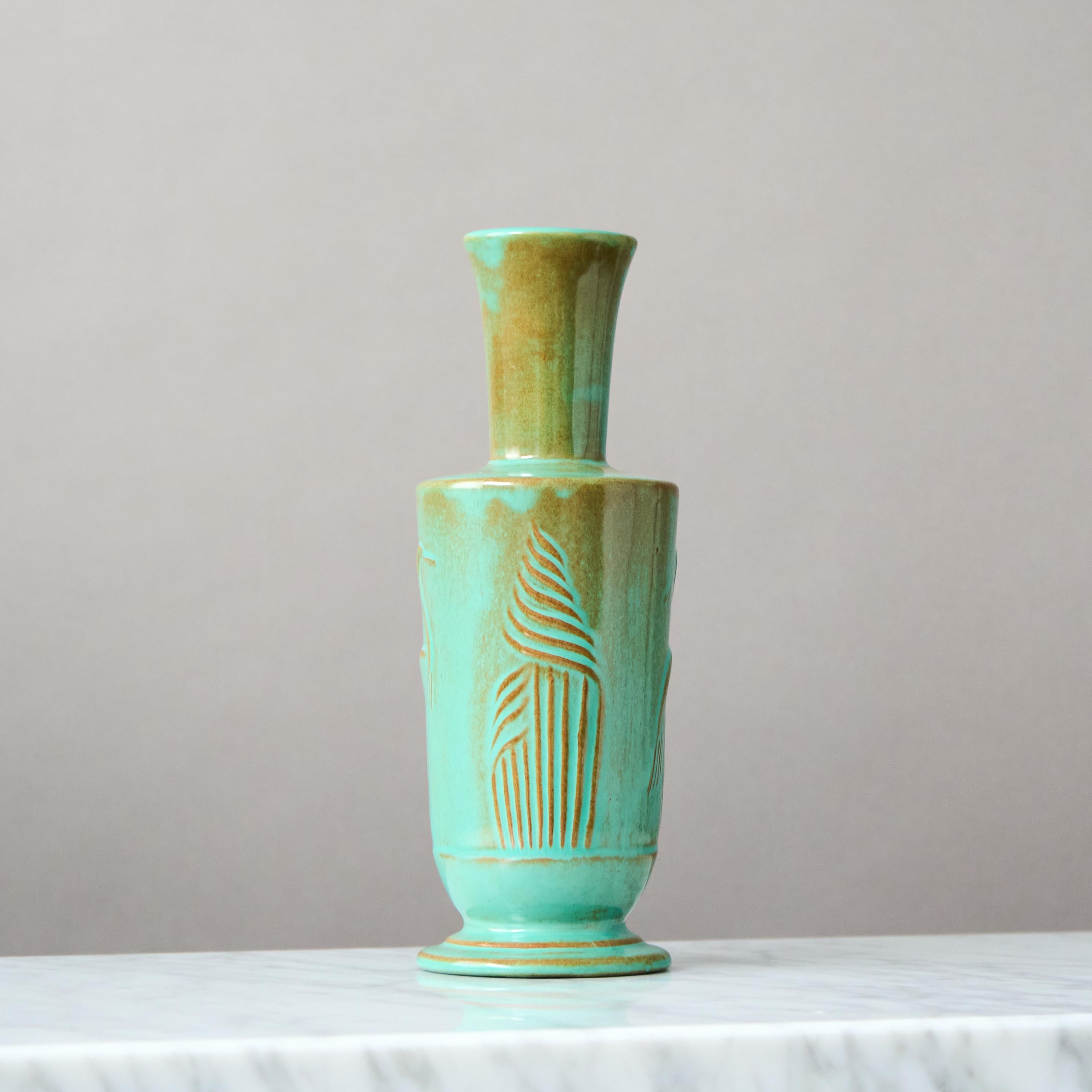 A rare and beautiful Art Deco vase with amazing green glaze. 
Designed by Ewald Dahlskog for Bo Fajans (Bobergs Fajansfabrik), Sweden.

This model was first exhibited at the Stockholm Exhibition in 1930.

Great condition, but with a tiny chip