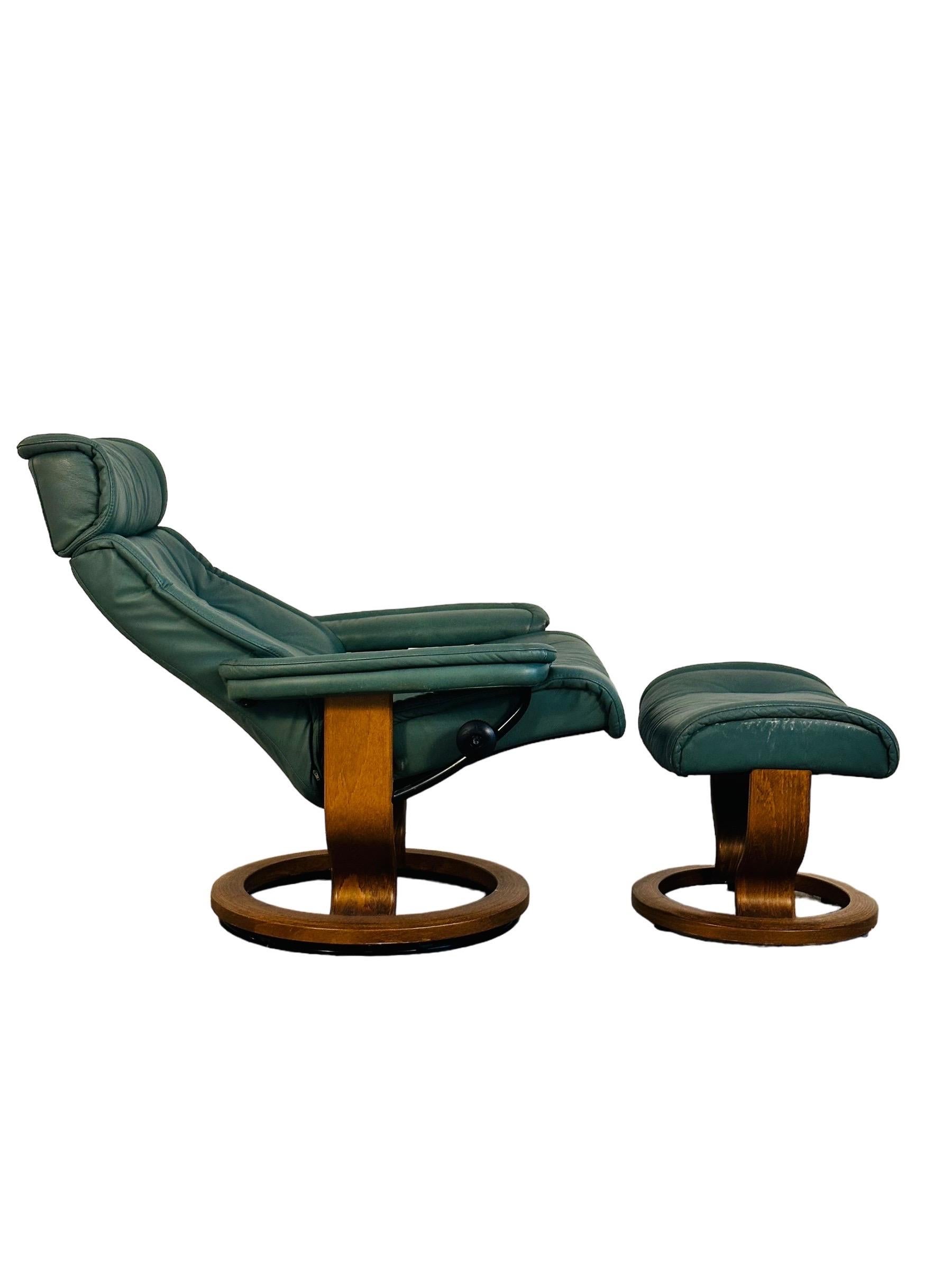 Step up your relaxation game with this eye-catching green Ekornes lounge chair and ottoman! It's not just a chair, it's your new favorite spot. With an adjustable headrest and the ability to swivel and recline, it's like a first-class seat in your