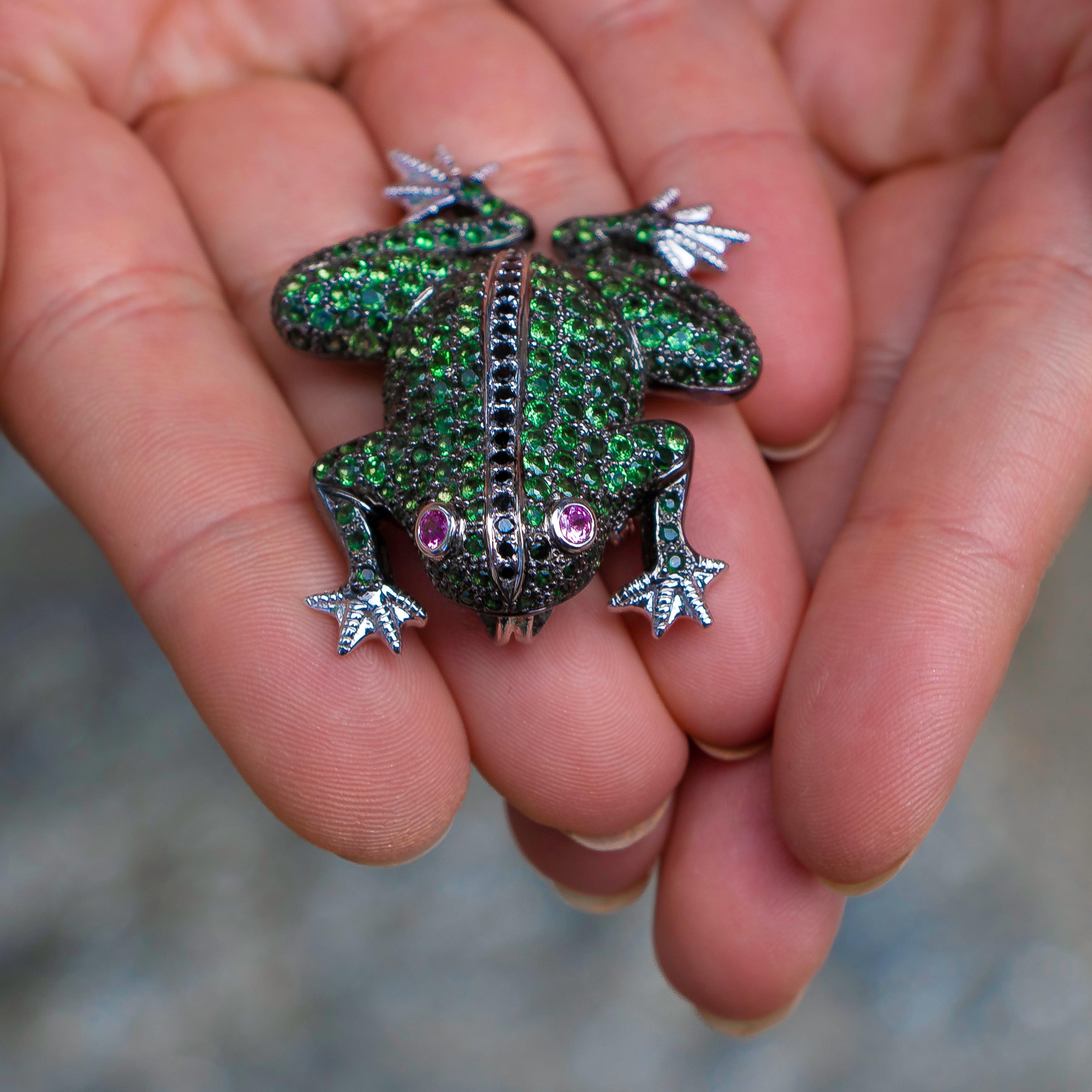 Adorable little green frog brooch with pink sapphire eyes, and a black diamond strip on its back. This brooch is different from any other brooch that I've ever come across, and it will always be a perfect addition to your outfit either as a brooch