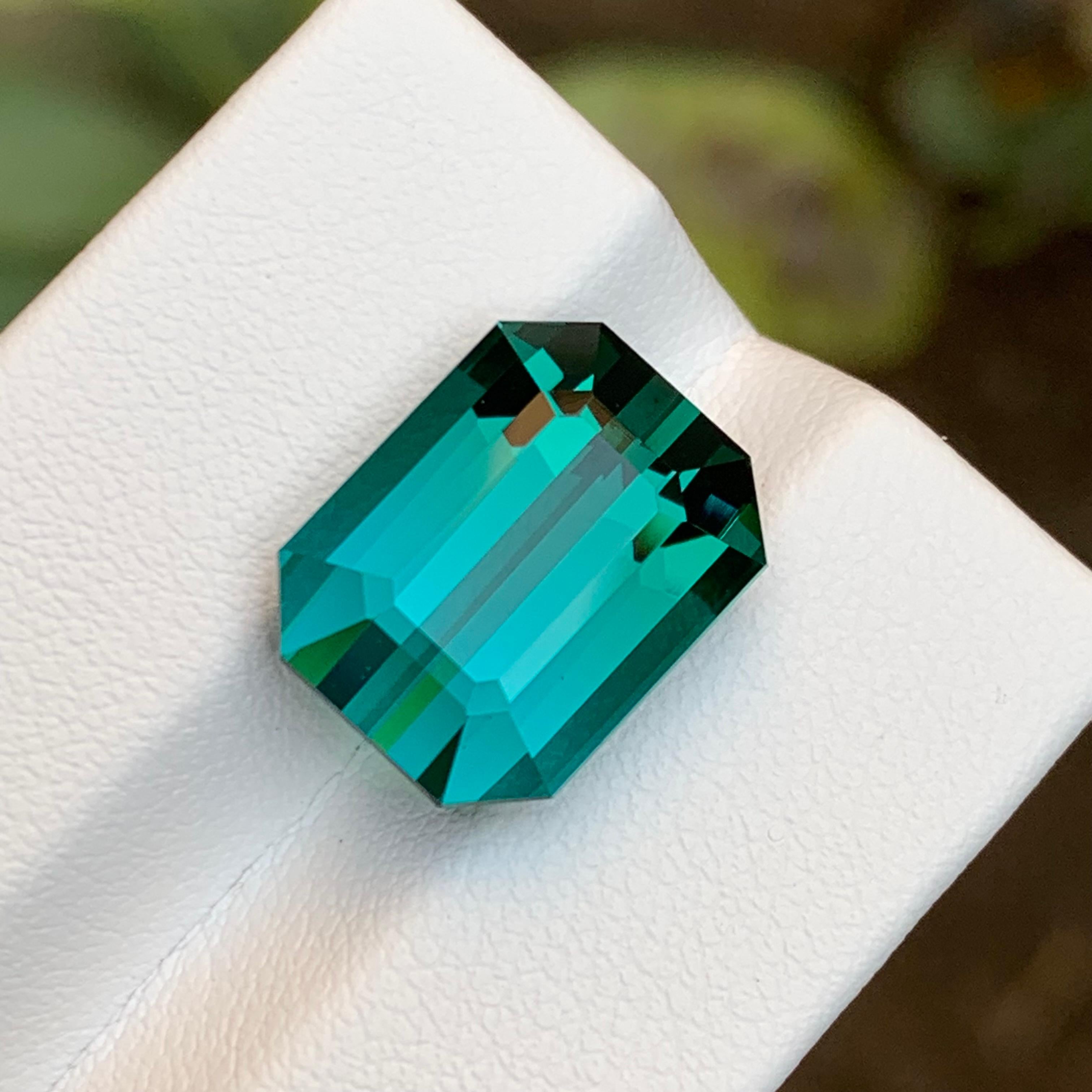GEMSTONE TYPE: Tourmaline
PIECE(S): 1
WEIGHT: 13.05 Carat
SHAPE: Emerald 
SIZE (MM):  14.43 x 11.17 x 8.97
COLOR: Greenish Blue
CLARITY: Loupe Clean
TREATMENT: Not treated
ORIGIN: Afghanistan
CERTIFICATE: On demand 

Behold a breathtaking rarity: a