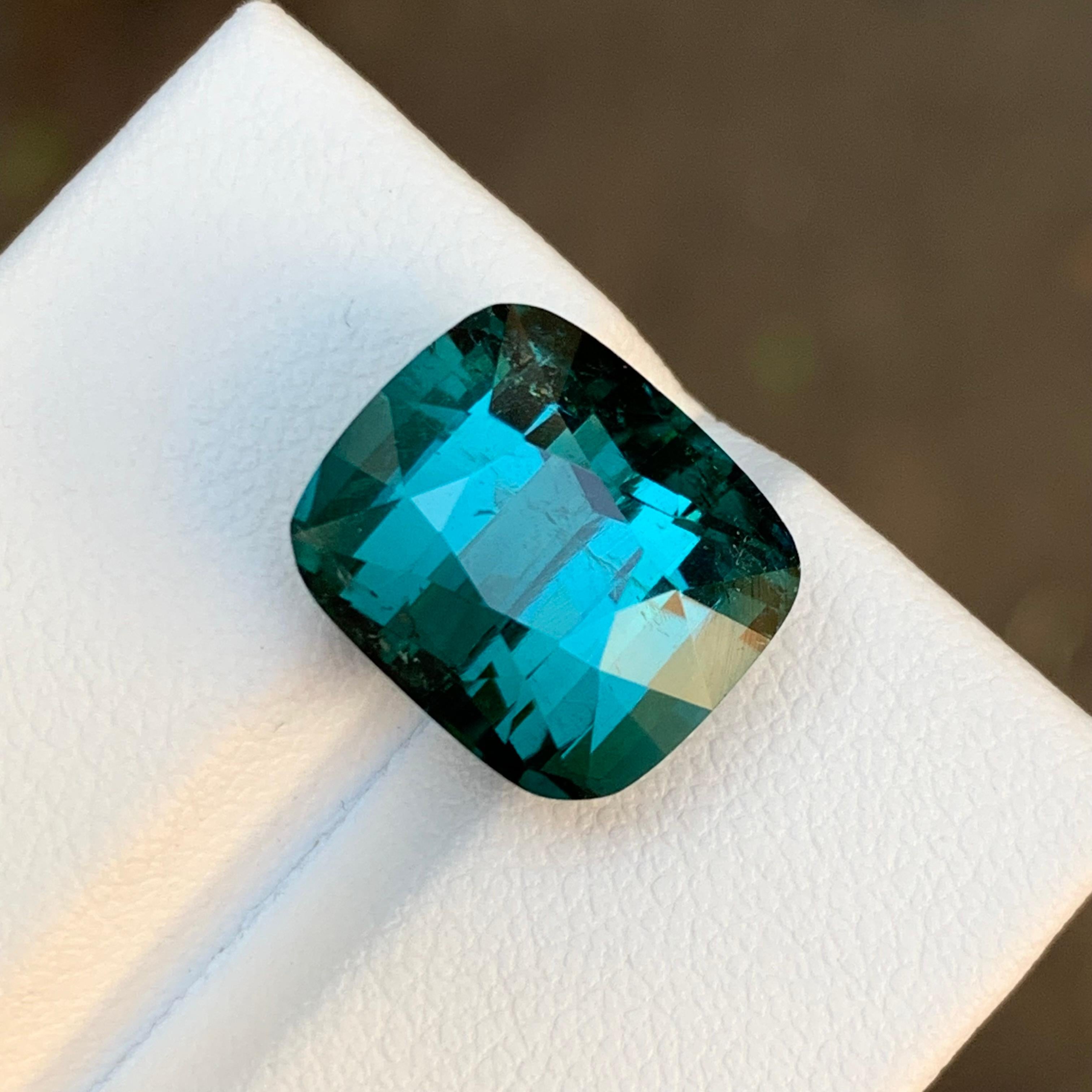 GEMSTONE TYPE: Tourmaline
PIECE(S): 1
WEIGHT: 9.20 Carats
SHAPE: Cushion Cut
SIZE (MM): 10.93 x 12.68 x 8.91
COLOR: Greenish Teal Blue
CLARITY: Slightly Included 
TREATMENT: None
ORIGIN: Afghanistan 🇦🇫 
CERTIFICATE: On demand
(if you require a