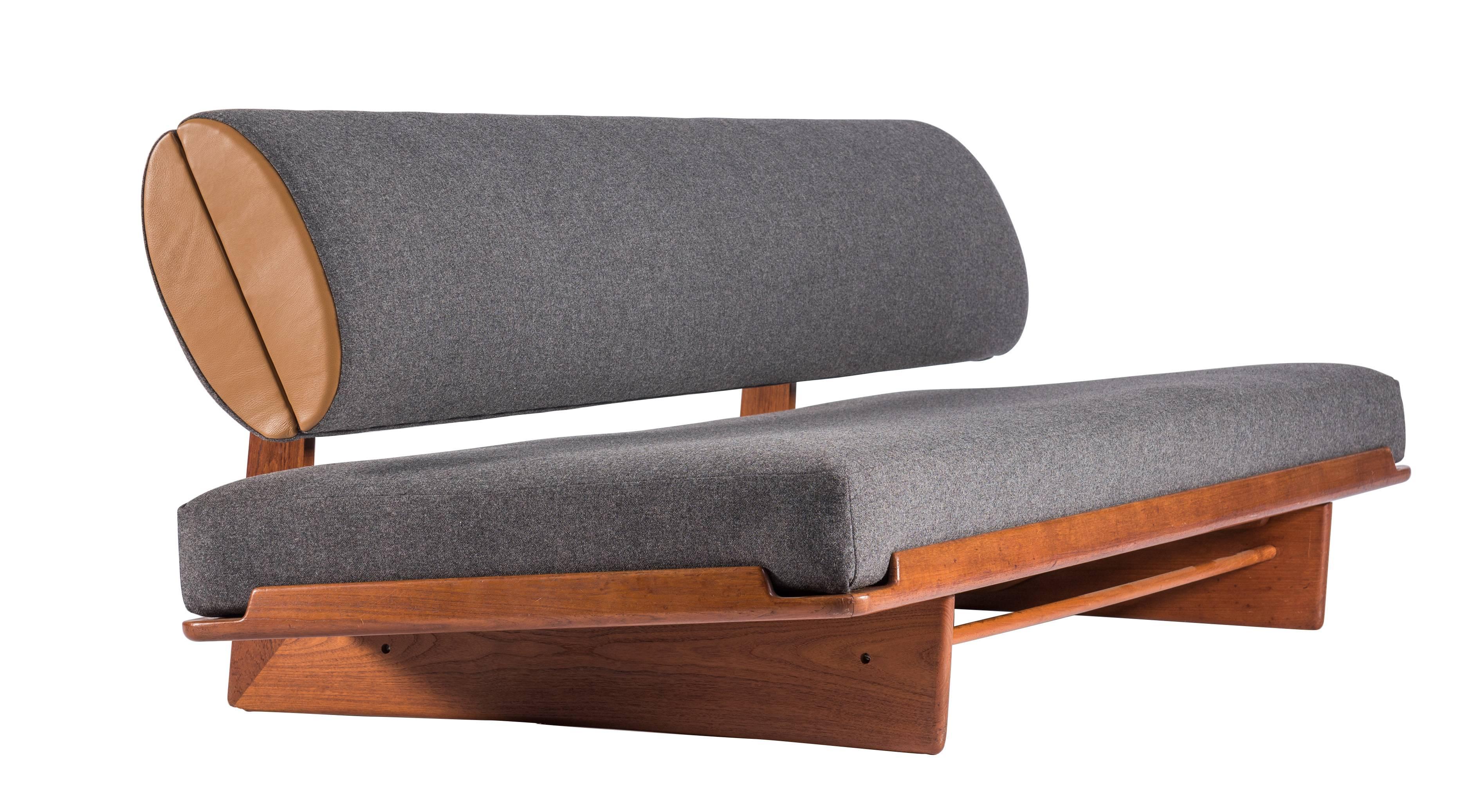 Rarely seen and intelligently designed daybed by Grete Jalk and manufactured by Jeppesen of Denmark. Teak and upholstered daybeds with convertible two position seat and a clever hinged back bolster concealing internal storage. Signed to bottom. The