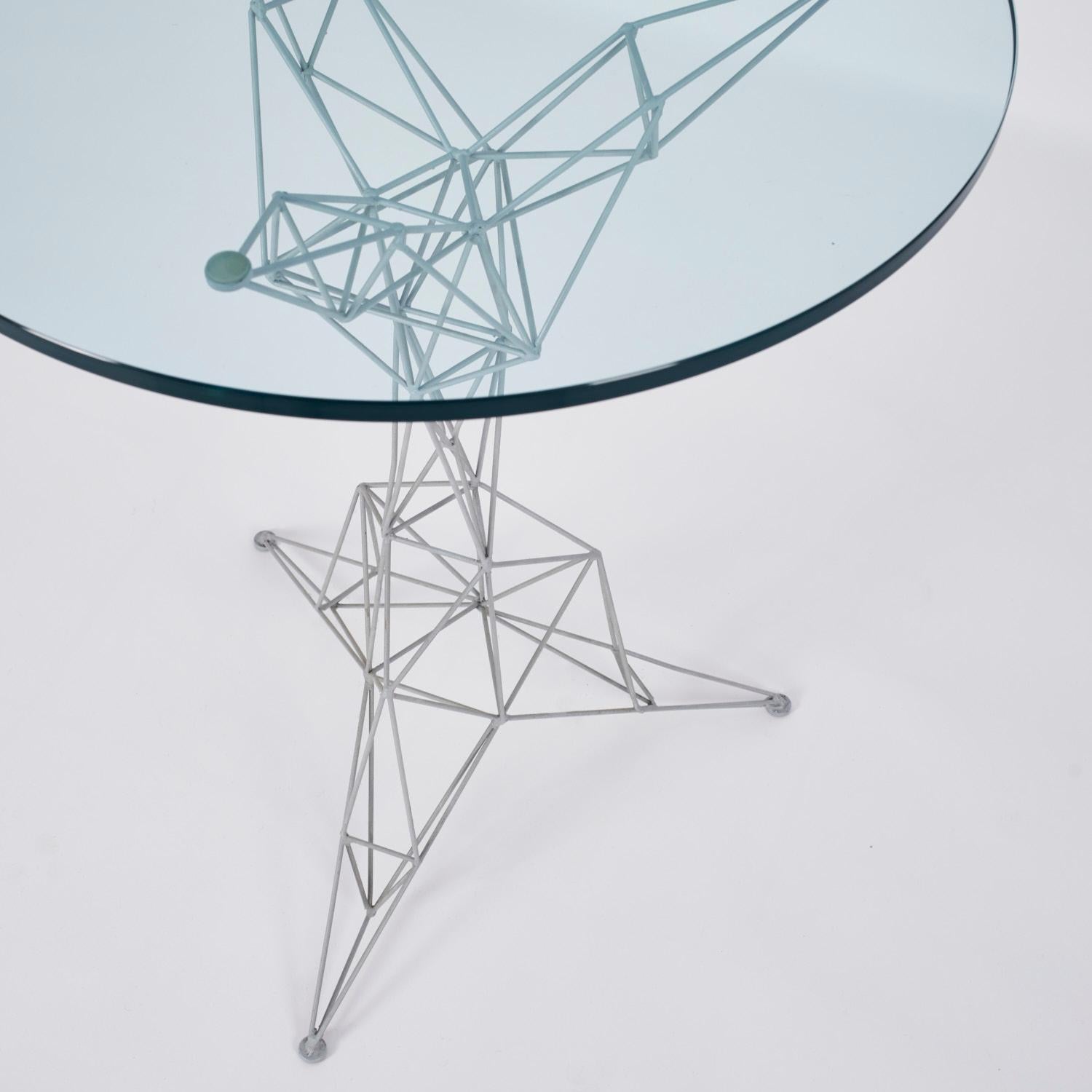 The Pylon series were intended to be light and architectural at the same time, if the chairs are pretty rare in their original Cappellini version, we can consider the table almost unique, and matches perfectly in its set. Most likely a gueridon, it