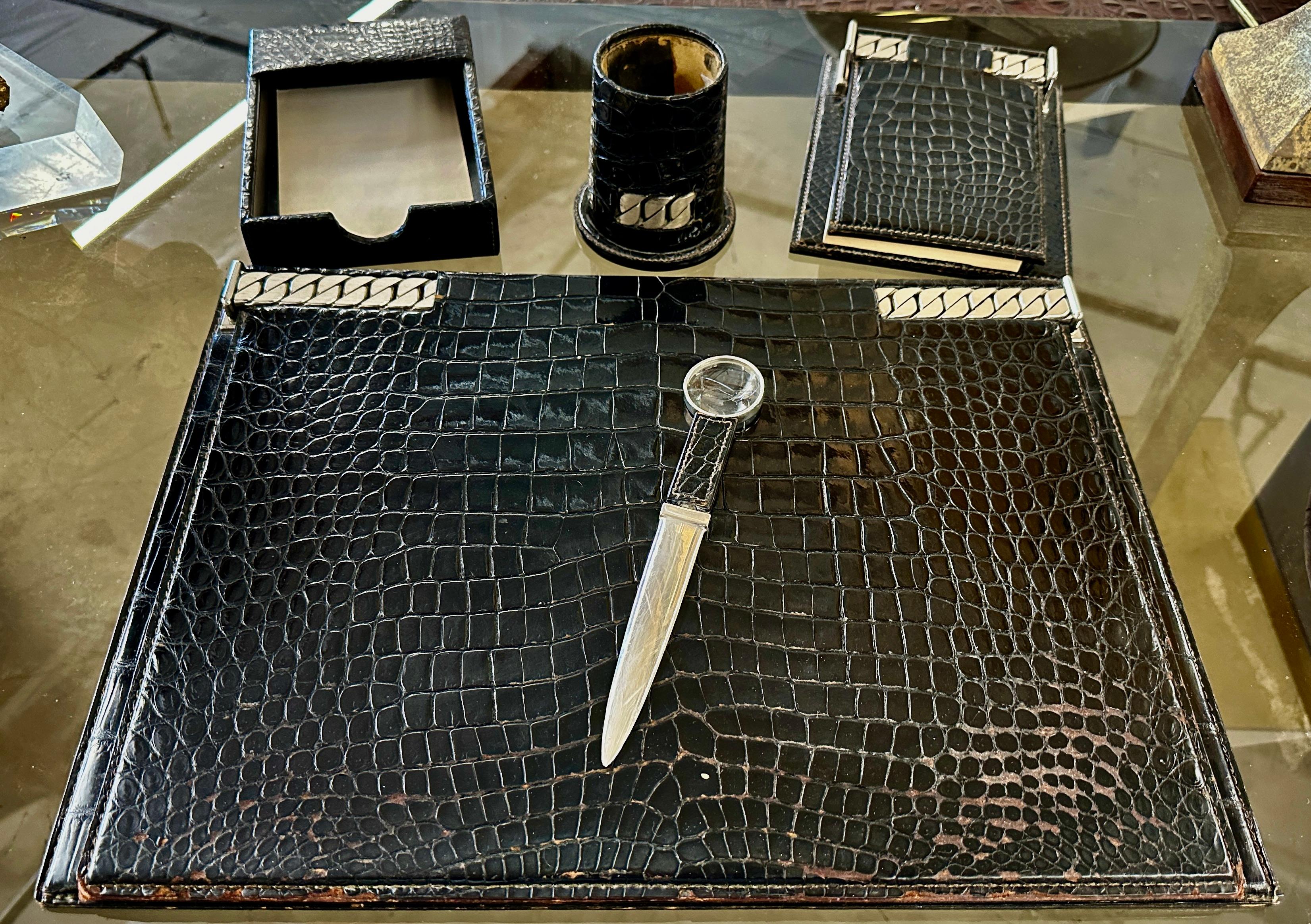 A fabulous and rare Gucci 5 piece desk set in either Alligator or Crocodile real leather or embossed leather. Likely from the 1970's although I've seen pieces attributed to the 1960's and special order. 
It's rare to find a set this complete. The