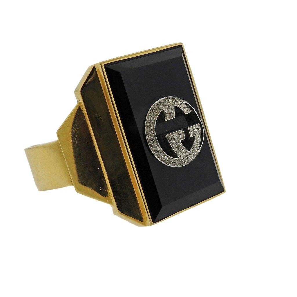  Rare and exquisite large Gucci cuff bracelet, featuring onyx top and approx. 0.75ctw in diamonds. Material - 18k Yellow Gold. Cuff will fit approx. 7