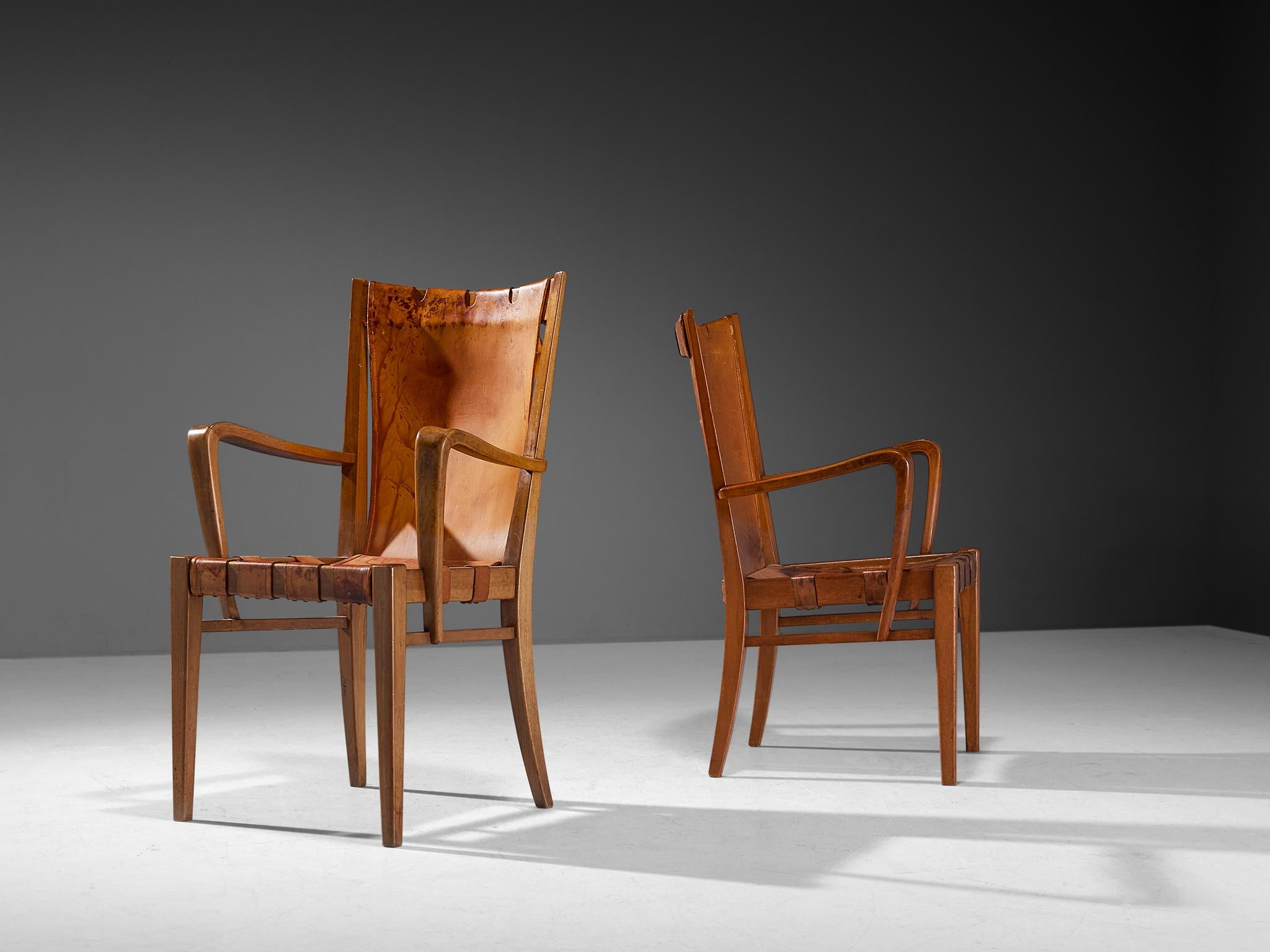 Guglielmo Pecorini, pair of dining chairs, walnut, leather, brass, Italy, circa. 1940 

These wonderfully sculpted chairs are designed by Italian designer Guglielmo Pecorini The sincere construction and type of upholstery, give the chair a