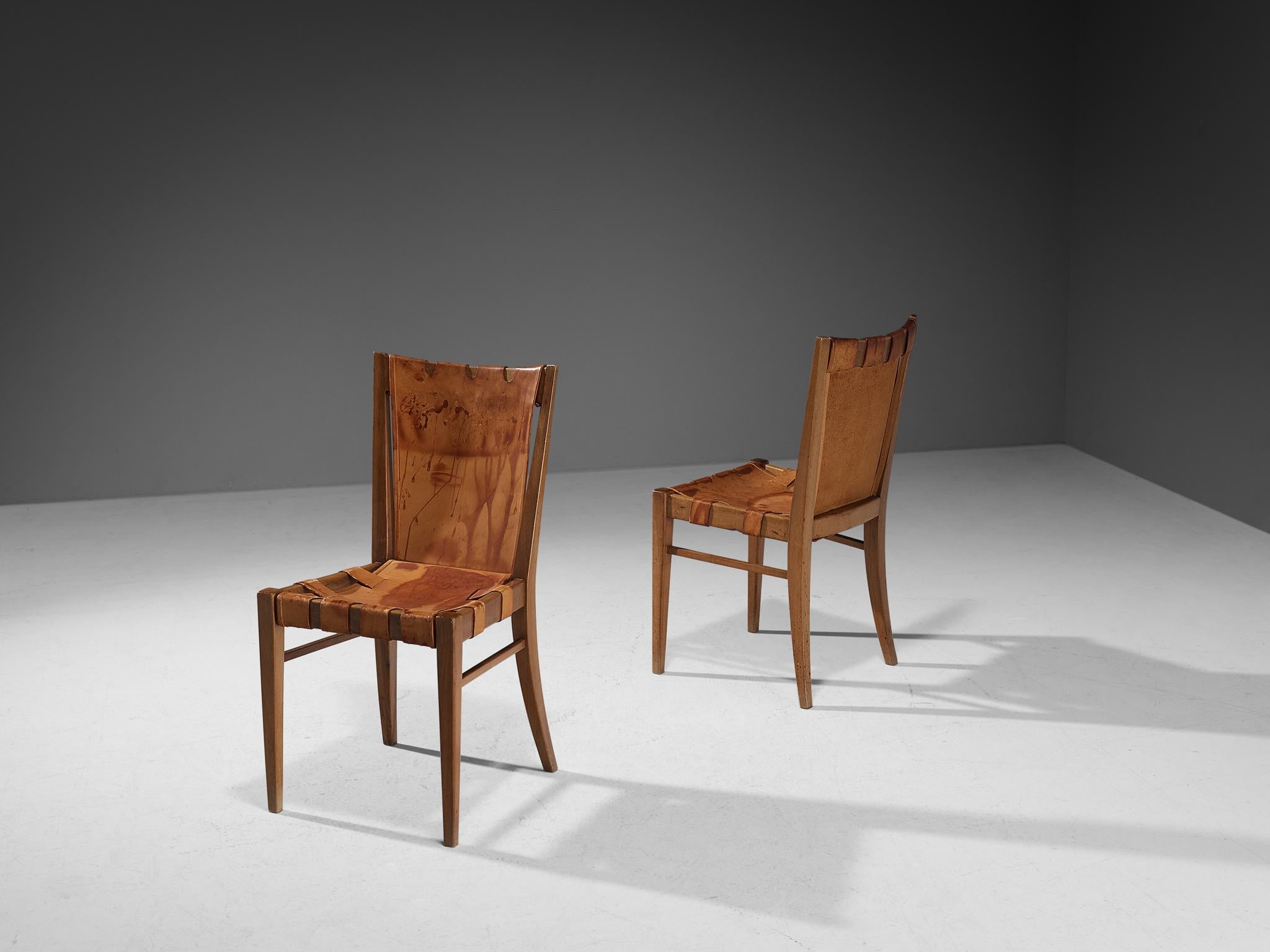 Guglielmo Pecorini, pair of dining chairs, walnut, leather, brass, Italy, circa 1940 

These wonderfully sculpted chairs are designed by Italian designer Guglielmo Pecorini The sincere construction and type of upholstery, give the chair a character