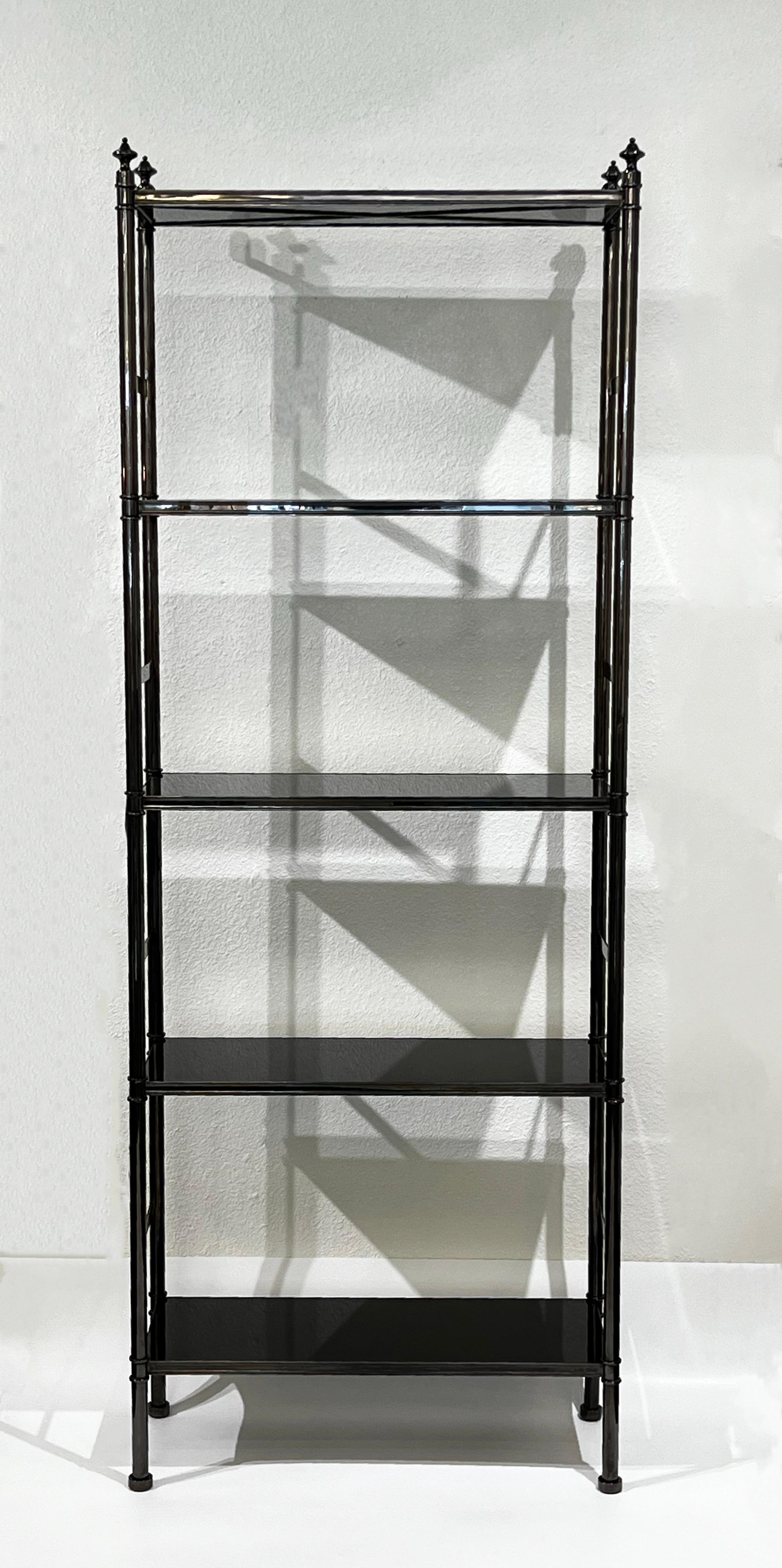 Rare 1970’s ‘Cole Porter Etagere’ or bookcase by Karl Springer. 
Constructed of metal with a polish gunmetal finish and black lacquered shelfs. 
It’s designed with adjustable brackets to anchor to wall, they can be removed if desired. 

It’s in
