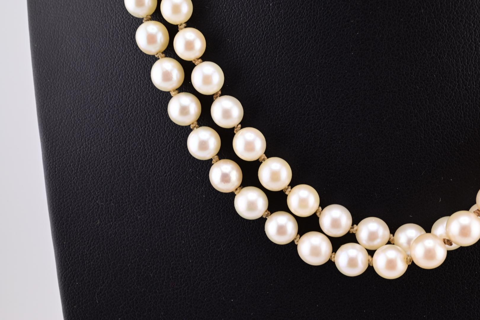 This elegant H. Stern necklace is a refined addition to any jewelry collection. Crafted with 18k gold, this beaded necklace showcases a double strand of round, white cultured pearls. The pearls' lustrous sheen is beautifully complemented by the warm