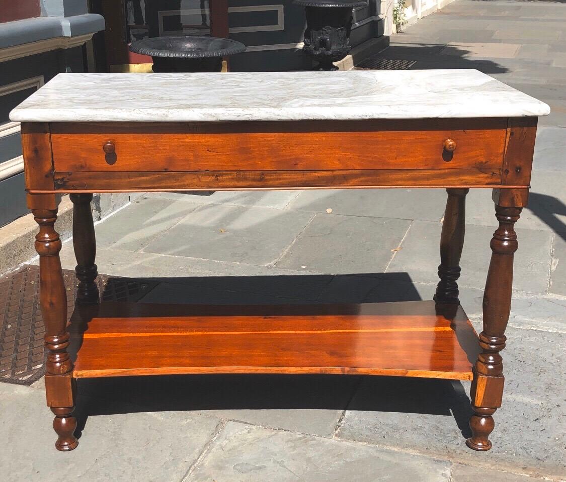 This exceptionally rare 19th century Haitian French Colonial Cedrela bakers table with marble top is unusual to fine in the Caribbean. This elegant table is made out of solid Cedrela and mahogany having provincial turned legs with one drawer in the