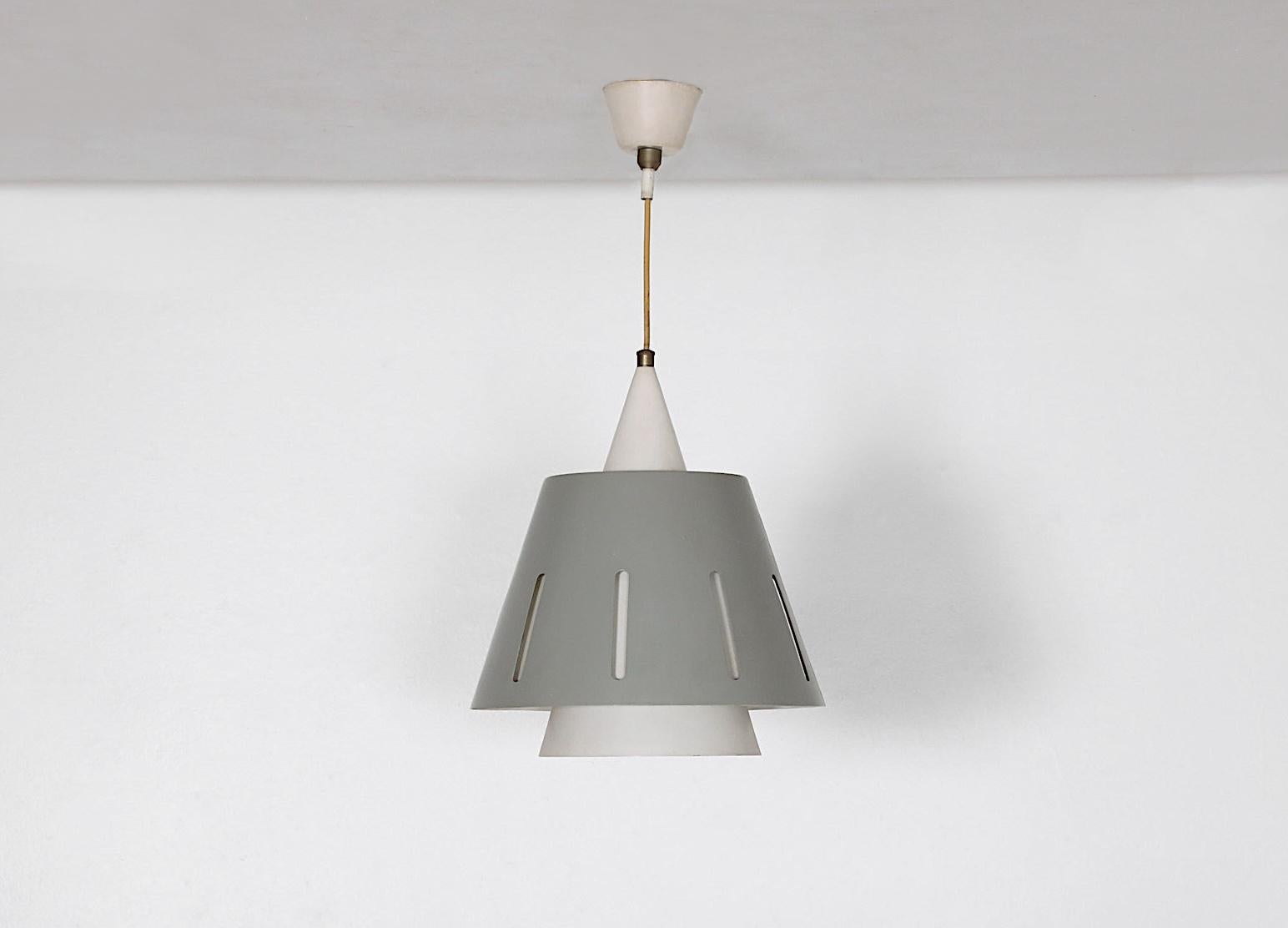 Vintage 'Zonneserie' or 'Sun Series' ceiling pendant by Herman Busquet for Hala Zeist, 1950s. Gray enameled metal outer shade and bone white metal interior.  In original condition with age appropriate wear including some scratching consistent with