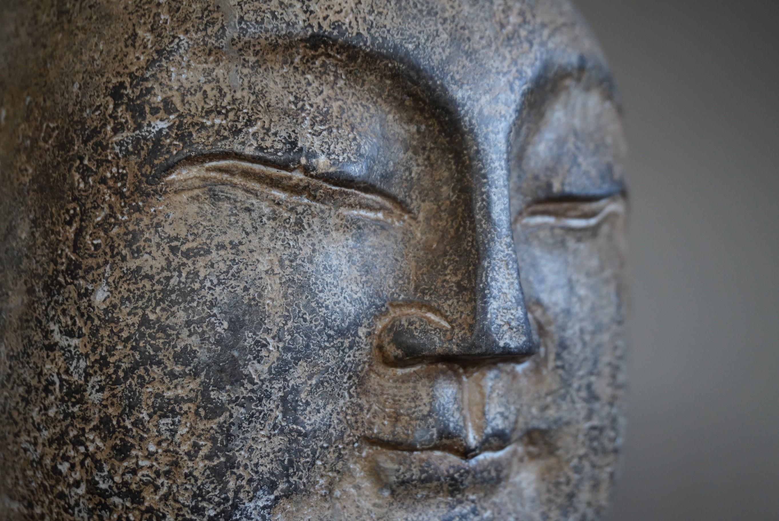 Stunning and one of a kind Buddha sculpture.

There are only very few people in the world who can accurately date this hand carved marble or granite Japanese Buddha head sculpture. Unfortunately, we do not know people who can. We did find out that