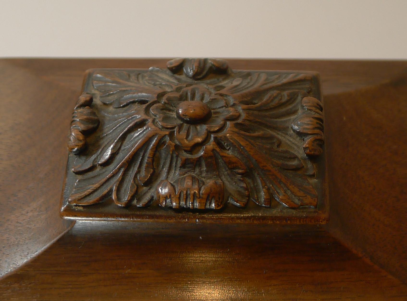 One of the finest desk calendars we have ever come across; it has been beautifully hand carved to the front, top and even the little knobs to each side are hand carved wood.

Standing on four bracket feet and dating to c.1900, late Victorian in