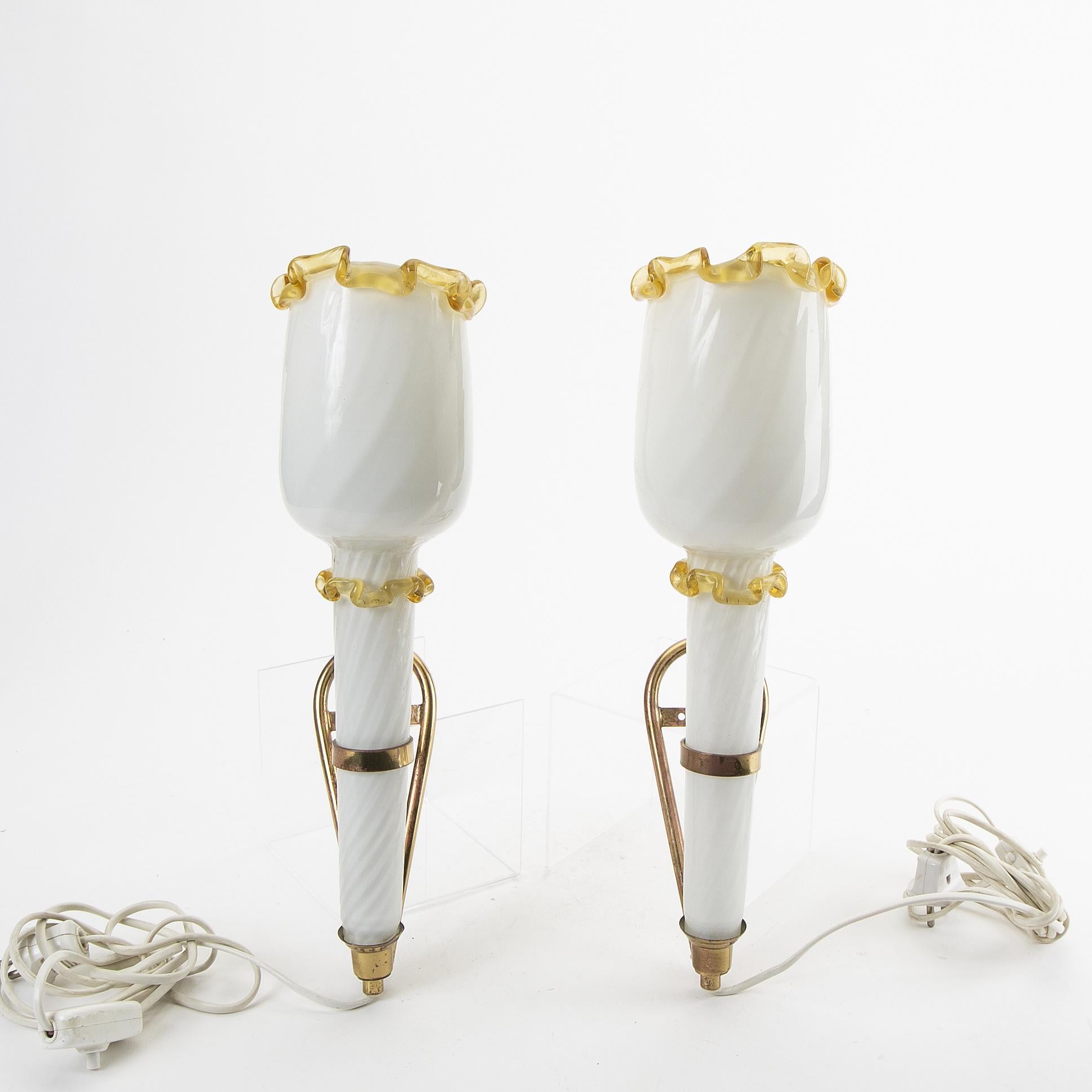Rare pair of sconces hand made in Murano Italy in 1060. White translucent glass and yellow glass. 
Mounted on brass.
   