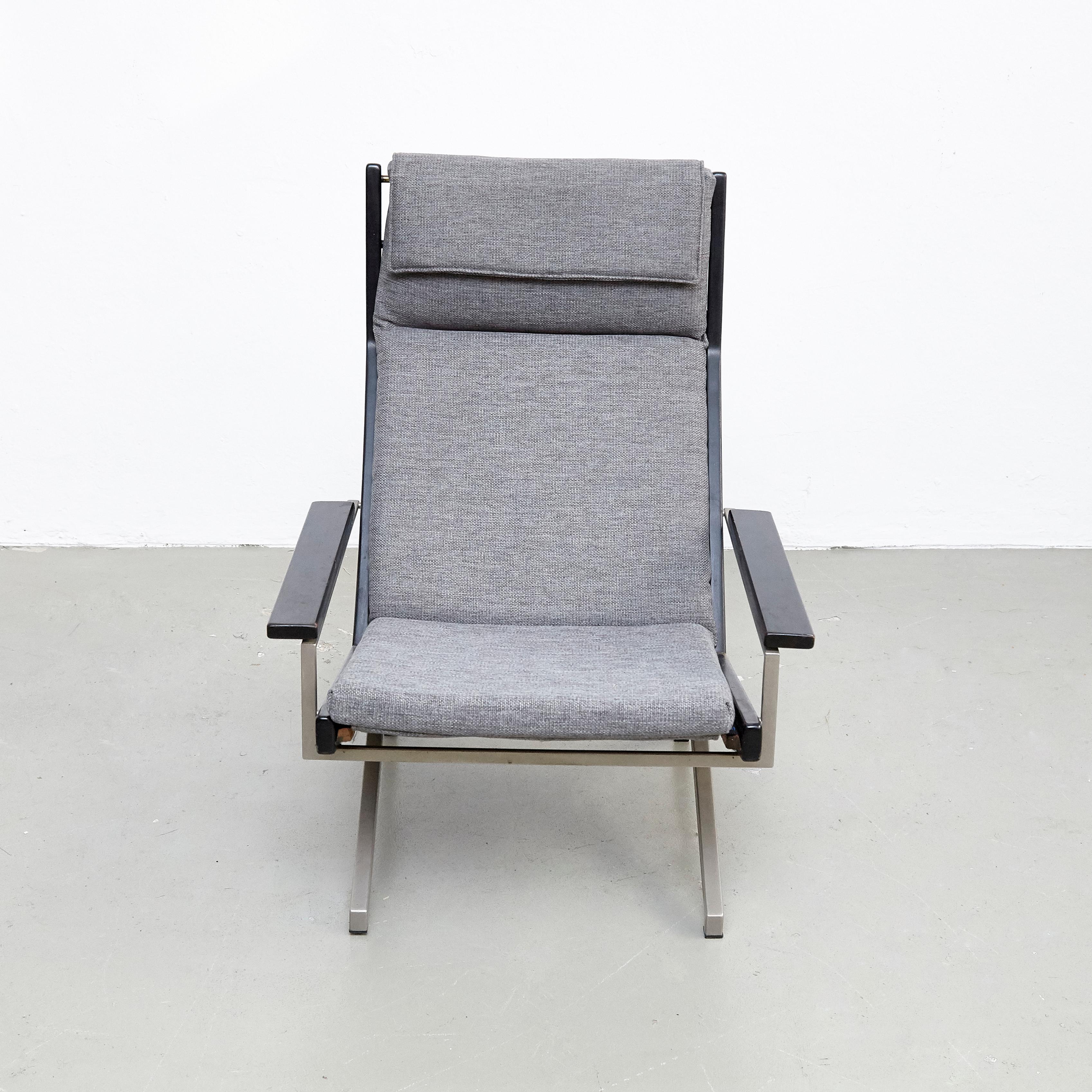 Easy chair designed by Rob Parry, manufactured by Gelderland (Netherlands) circa 1960.

Hand Signed by the Designer in Pen.

The chair has a beautiful steel base, wooden armrests and side panels.
It has been reupholstered.

In good original