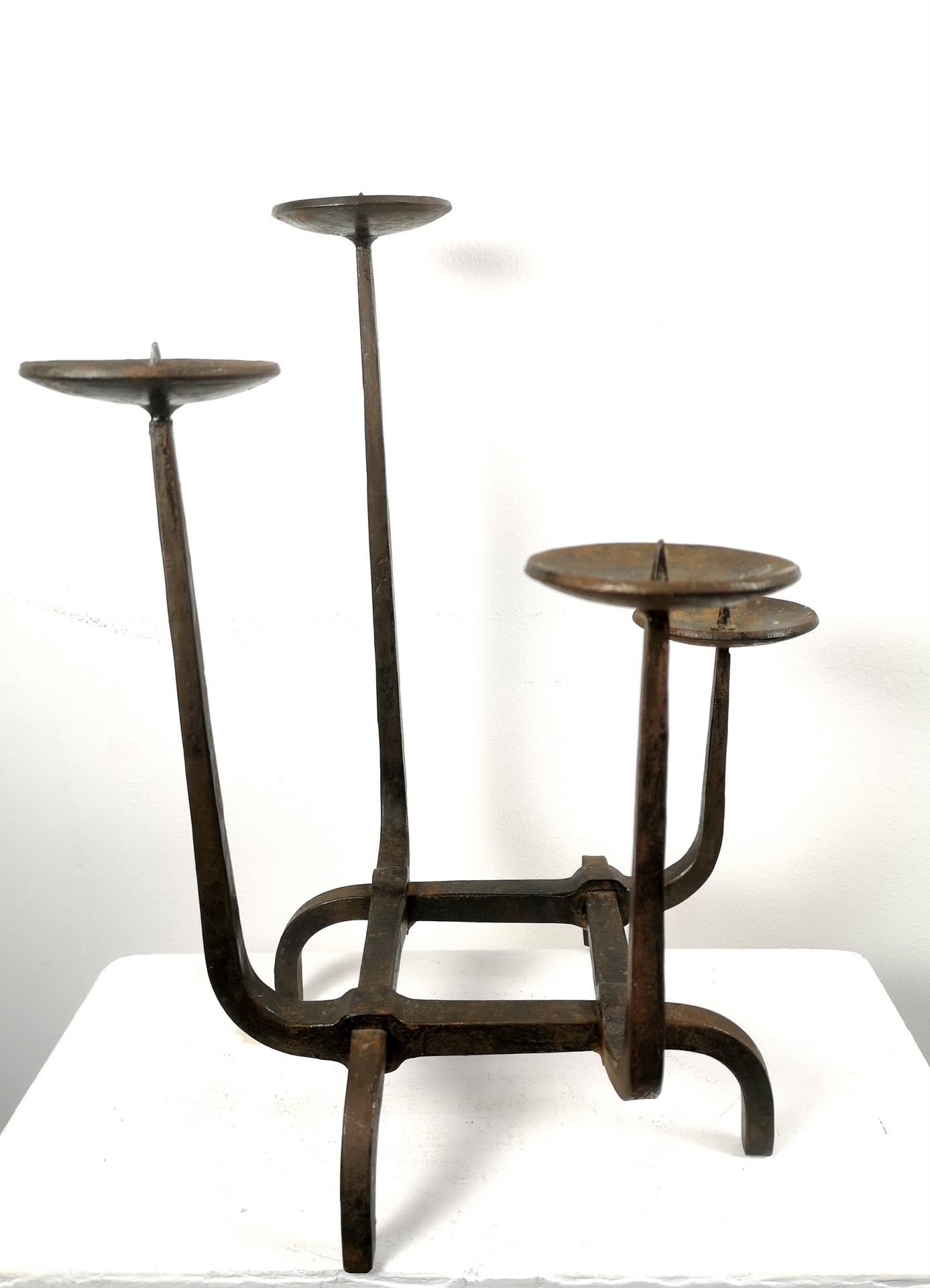 This hand-hammered iron candelabra has intertwining steel body with different height for different candles- it's a rare, large scale piece from the 1970's, and is signed Nausch (by Geza Nausch famous hungarian smith, metalsmith, born 1941).

